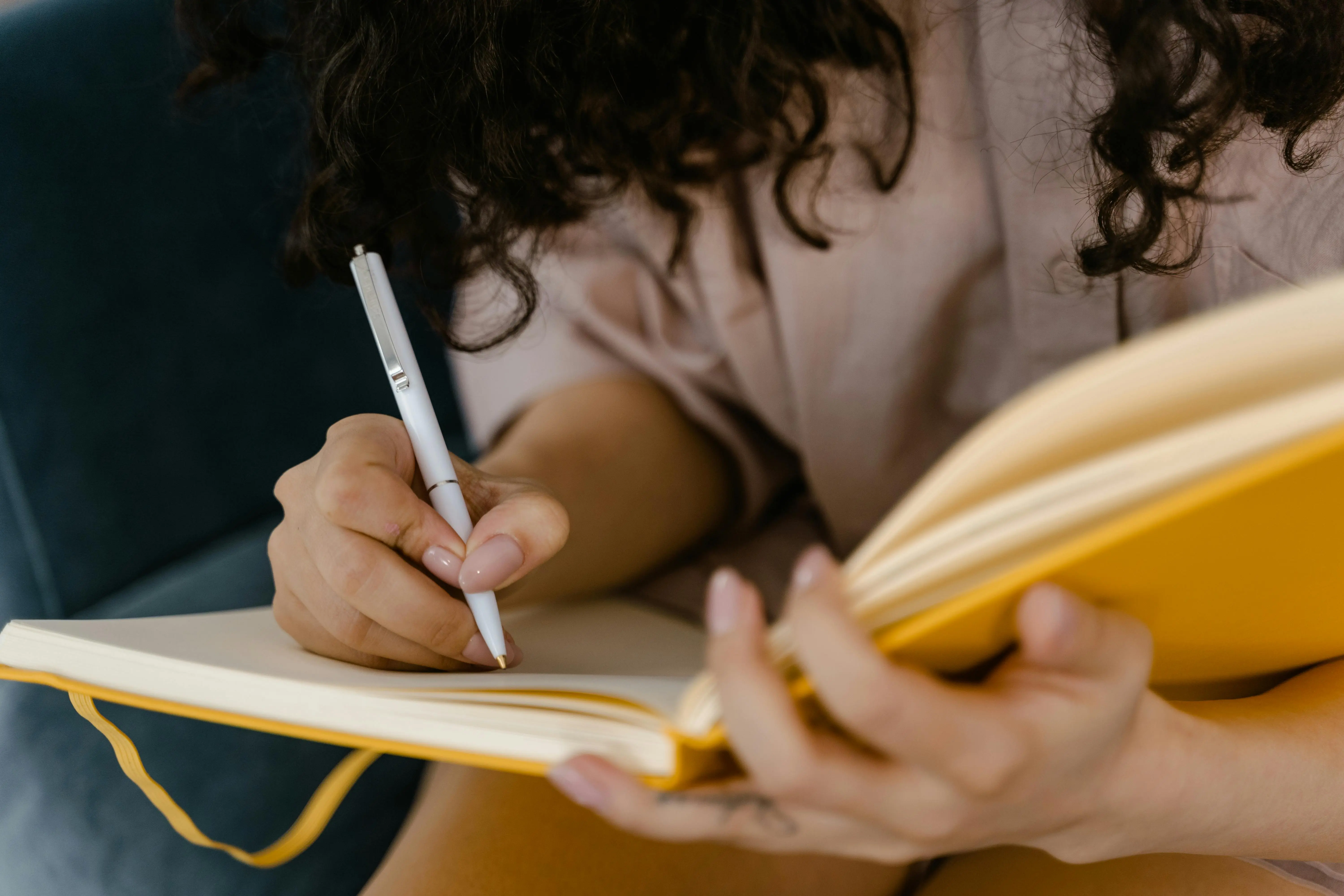 baby bed bugs Person writing in a yellow notebook indoors, focusing on ideas.