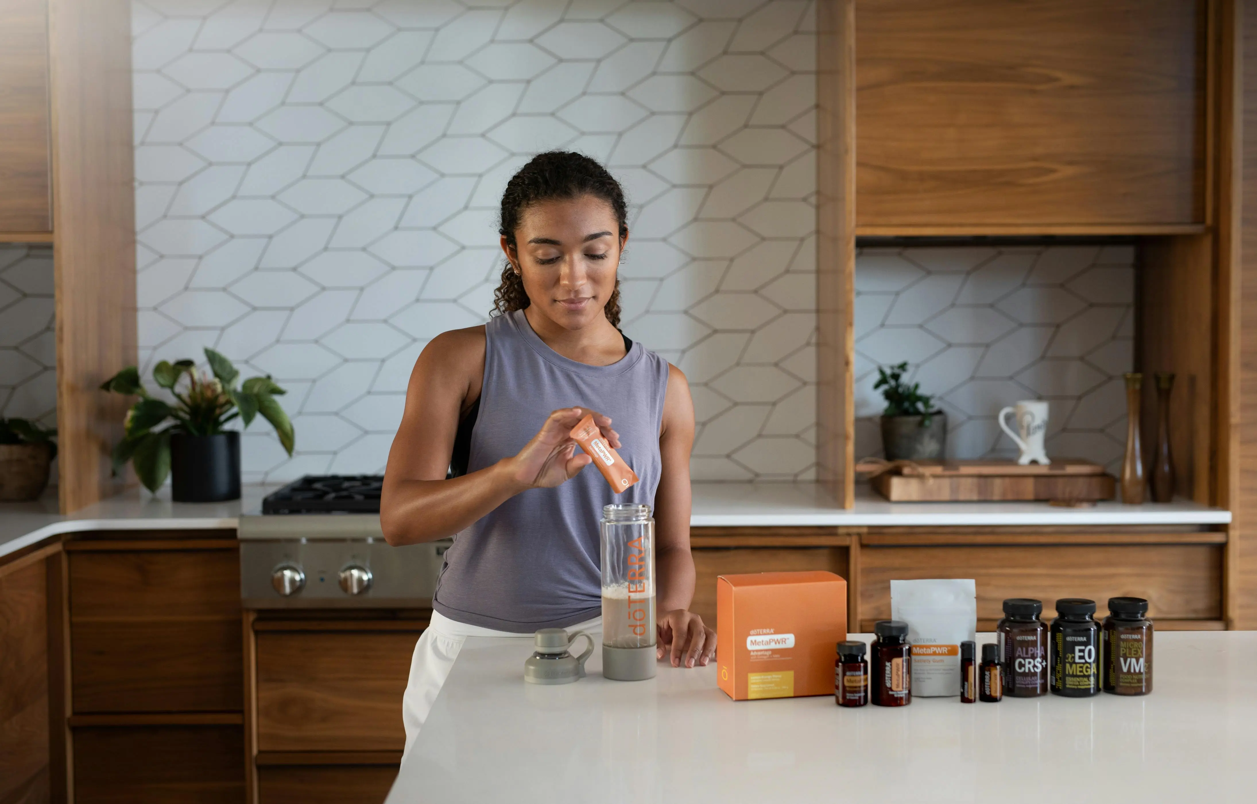 homemade laundry detergent A woman uses essential oils and supplements in a contemporary kitchen for wellness.