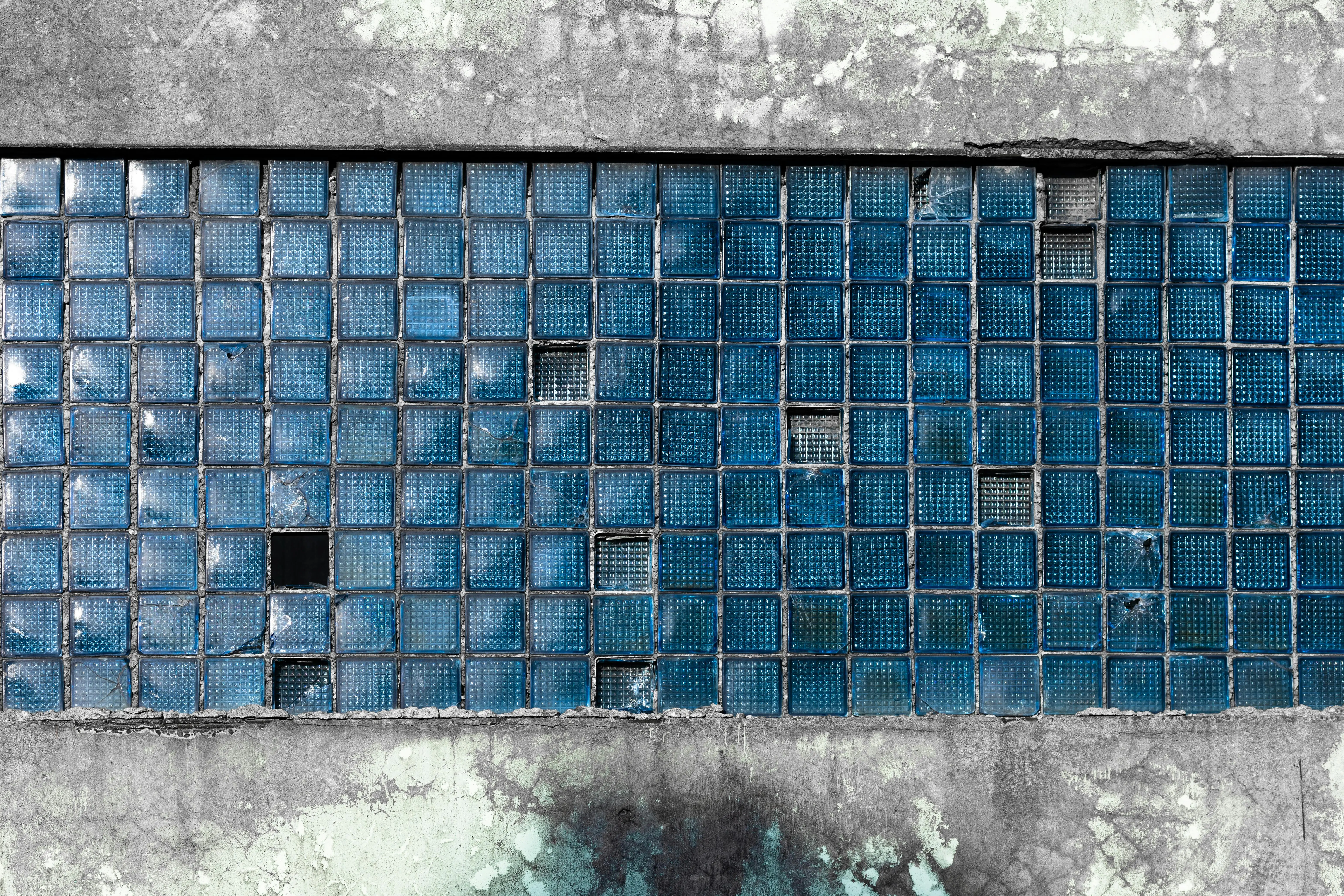 wood wall art decor Close-up of a weathered blue glass tile wall with texture and cracks.