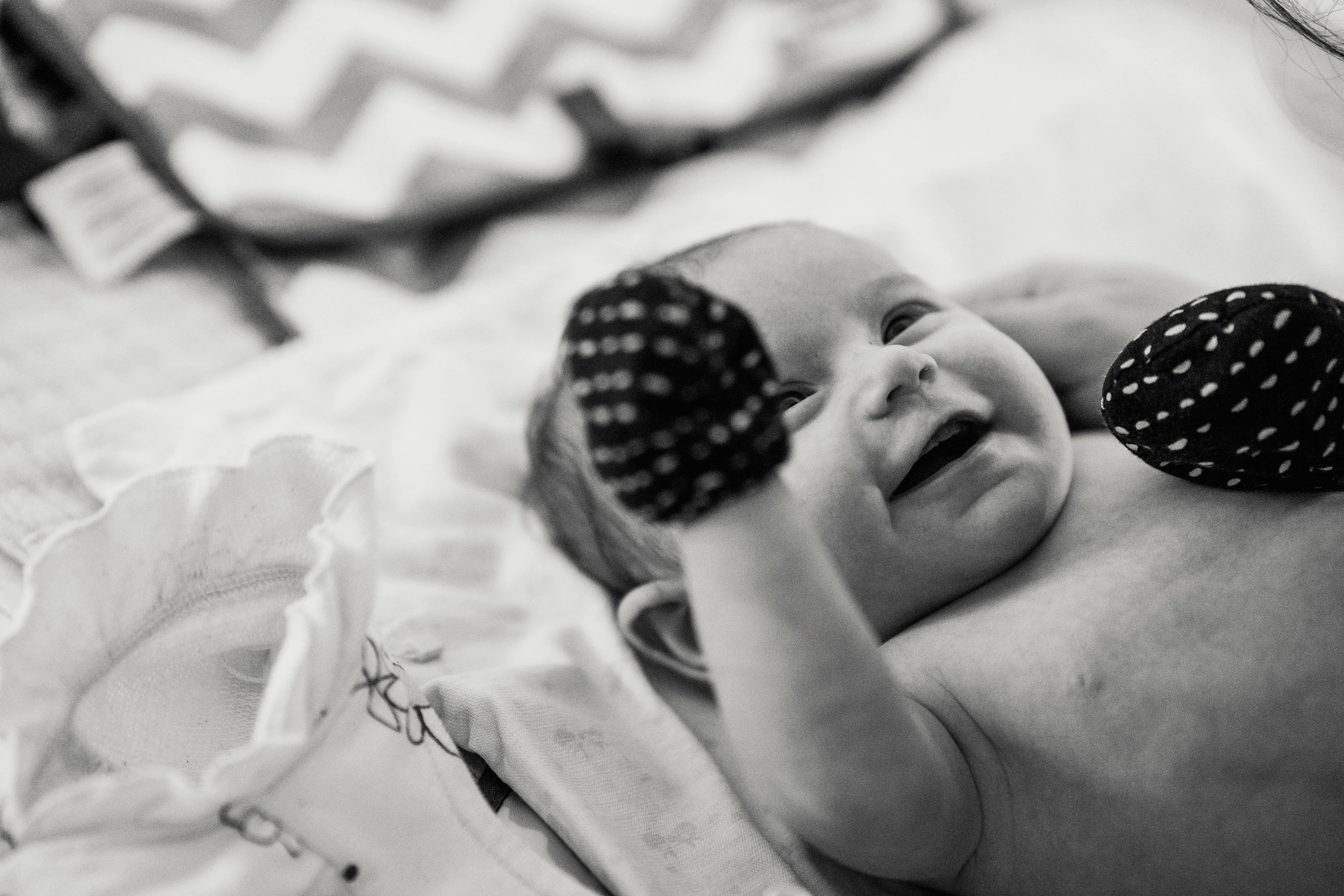 full size bed with storage Adorable baby smiling in black and white photo, showcasing innocence and joy.