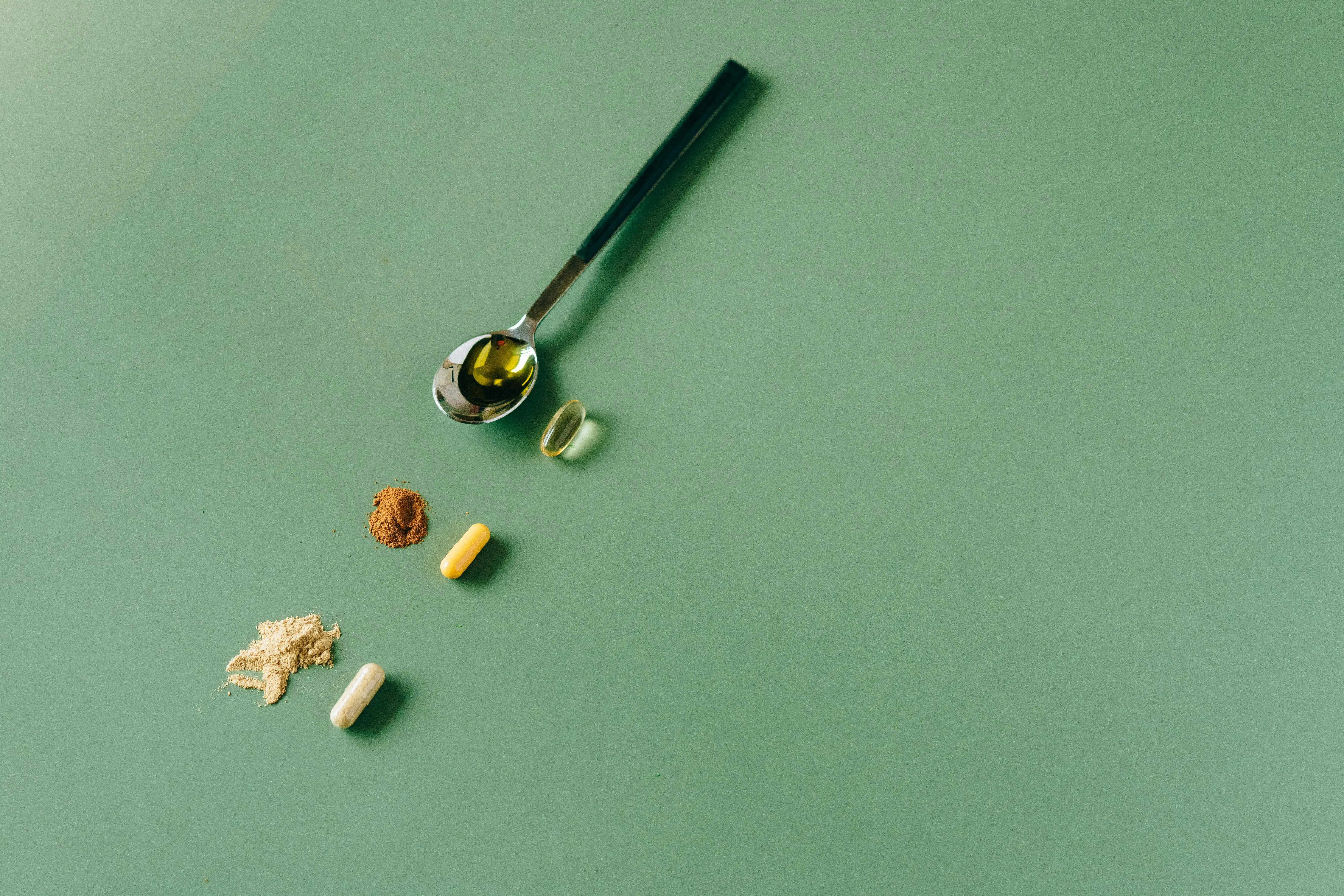 trailing indoor plants Assorted herbal supplements and powders on a green backdrop with a spoon.