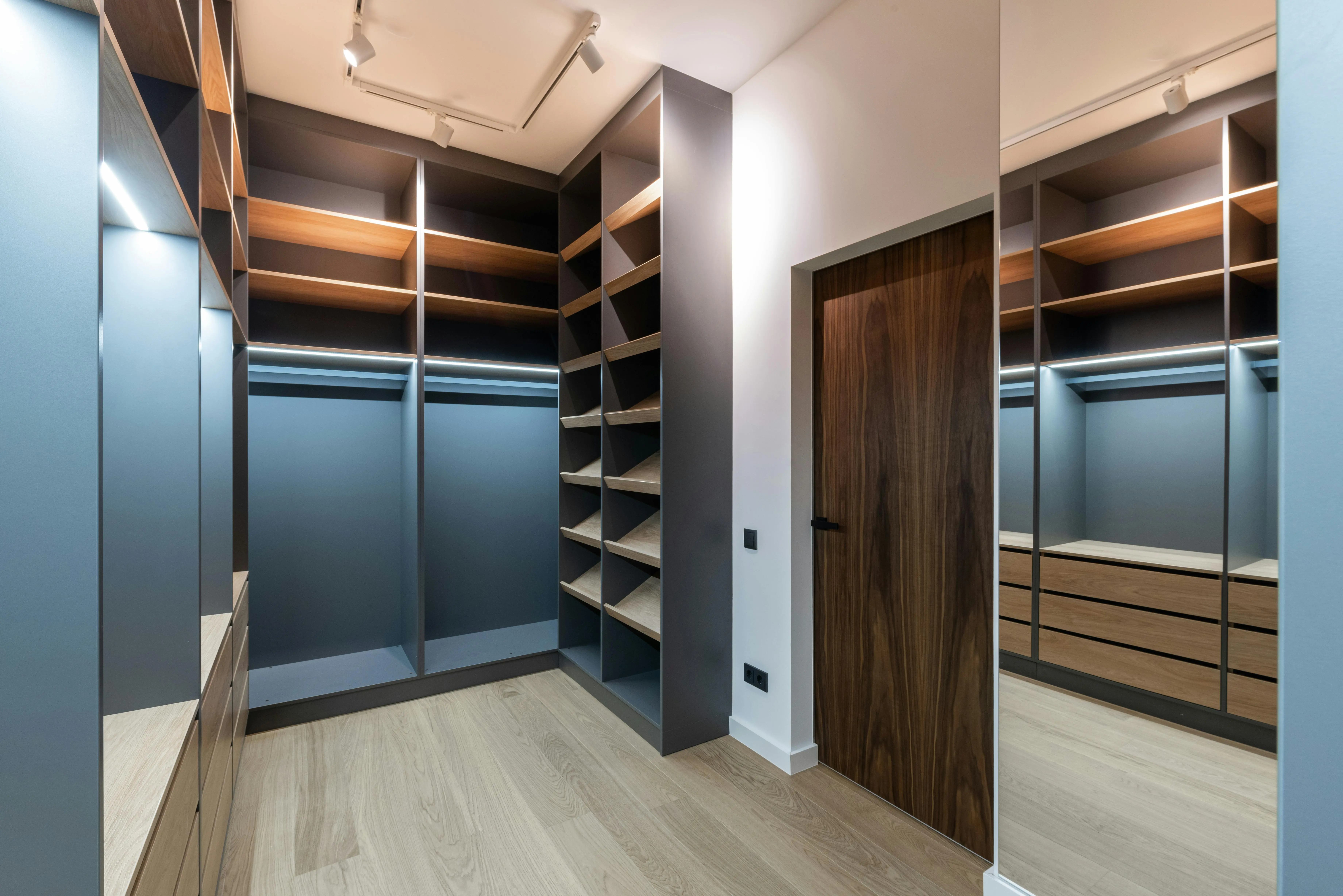 wire closet shelving Spacious modern walk-in closet with wooden shelves and sleek finishes.