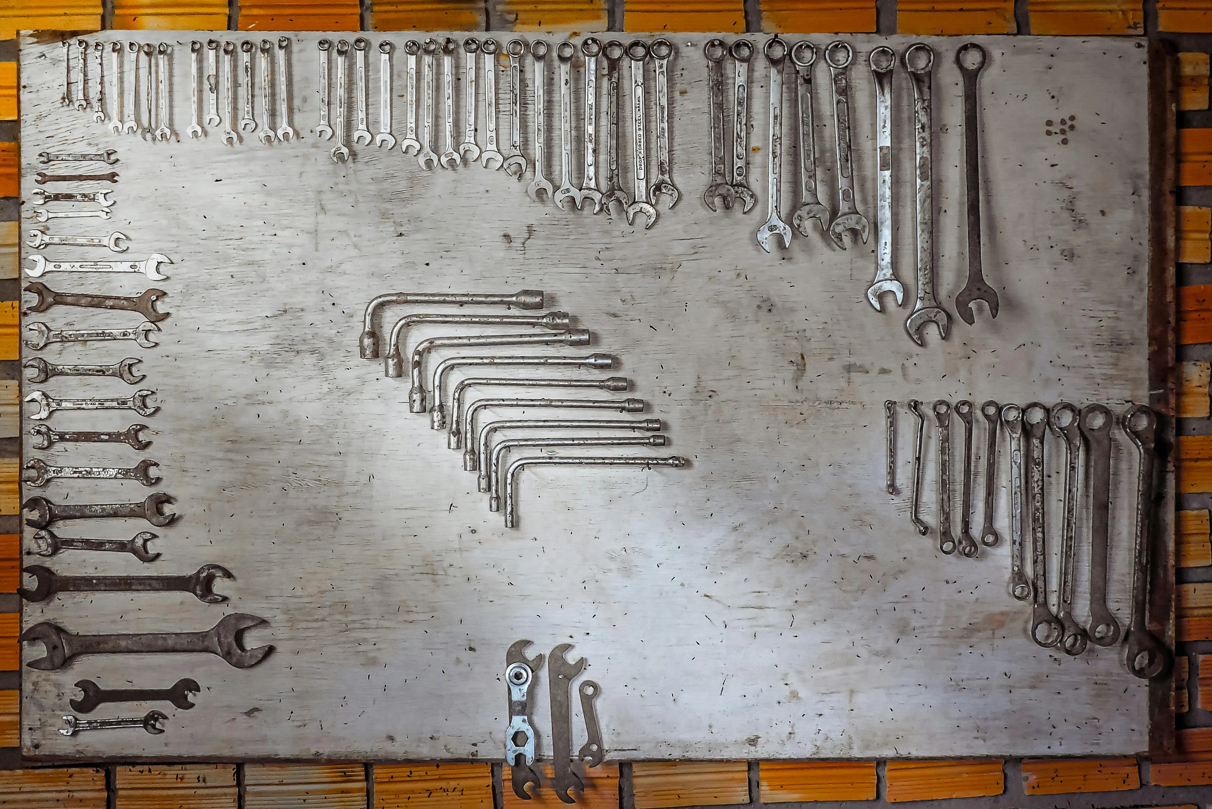 how much is a penny floor per square foot diy Neatly arranged wrenches on a metal board, highlighting organization and DIY tools.