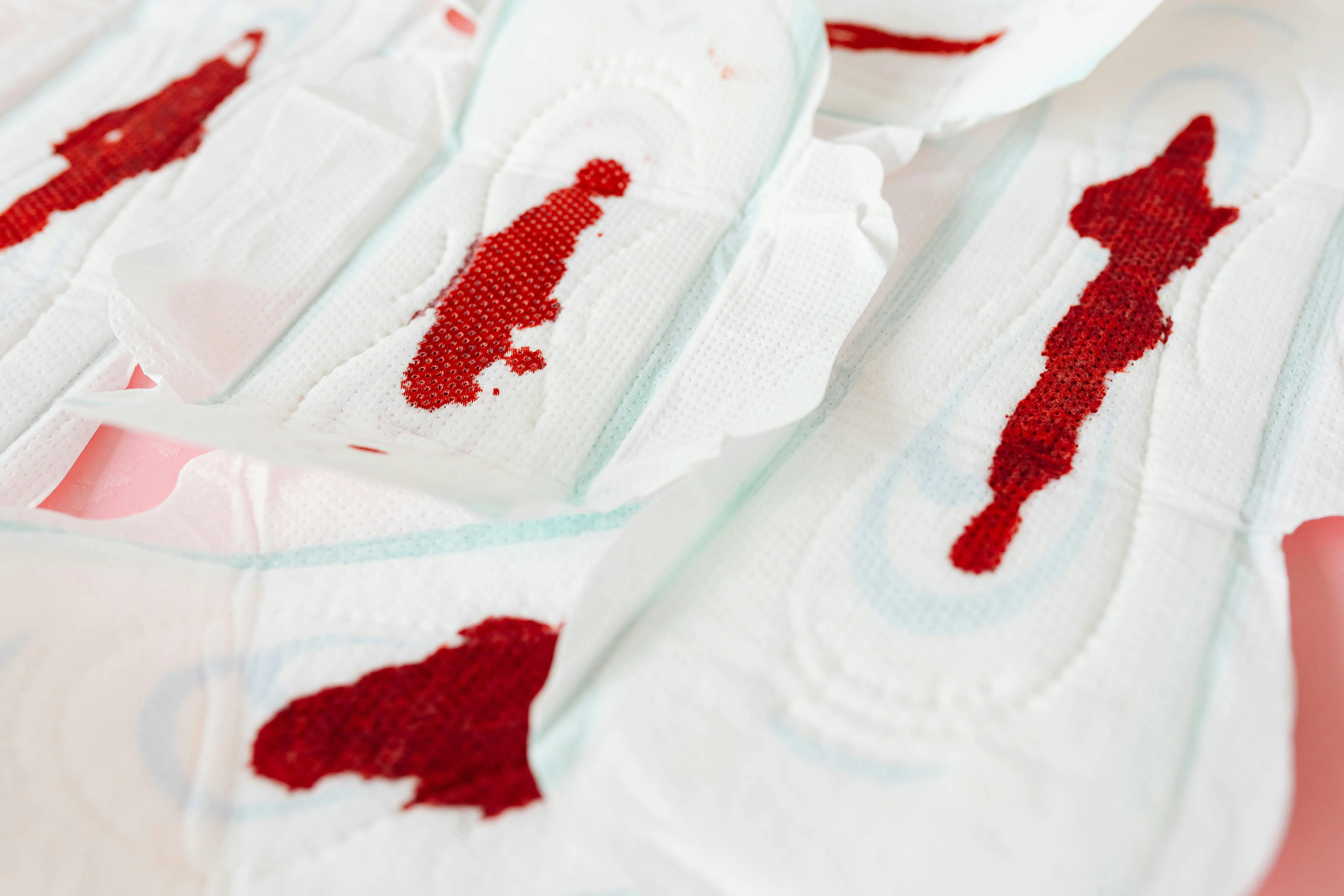how to get blood out of fabric Close-up of sanitary napkins showing menstrual blood stains during menstruation.