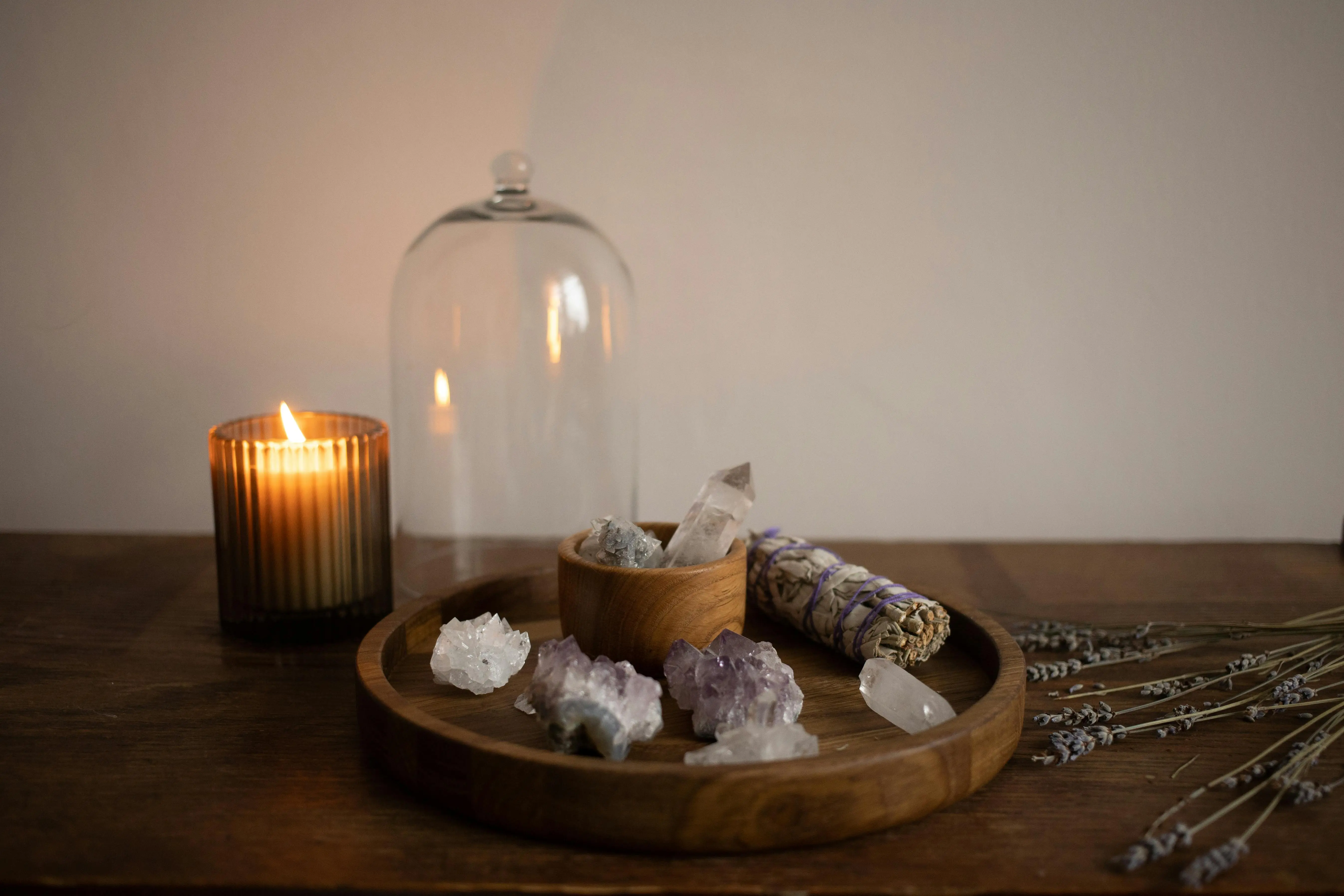 calacatta quartz A serene indoor setting featuring crystals, sage, and a candle on a wooden tray.