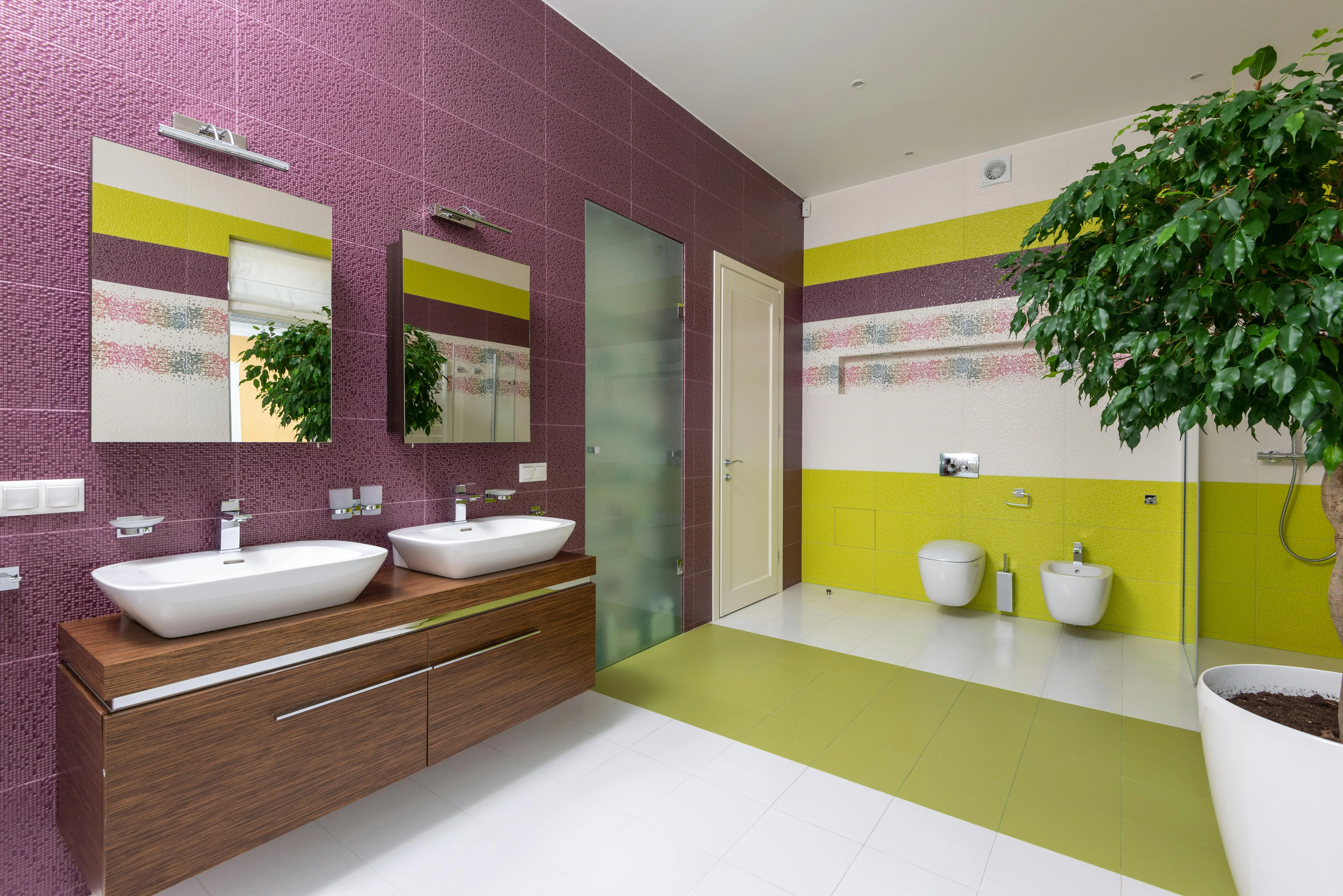 green tile Bright and colorful bathroom with contemporary fixtures, double sink, and decorative plant.