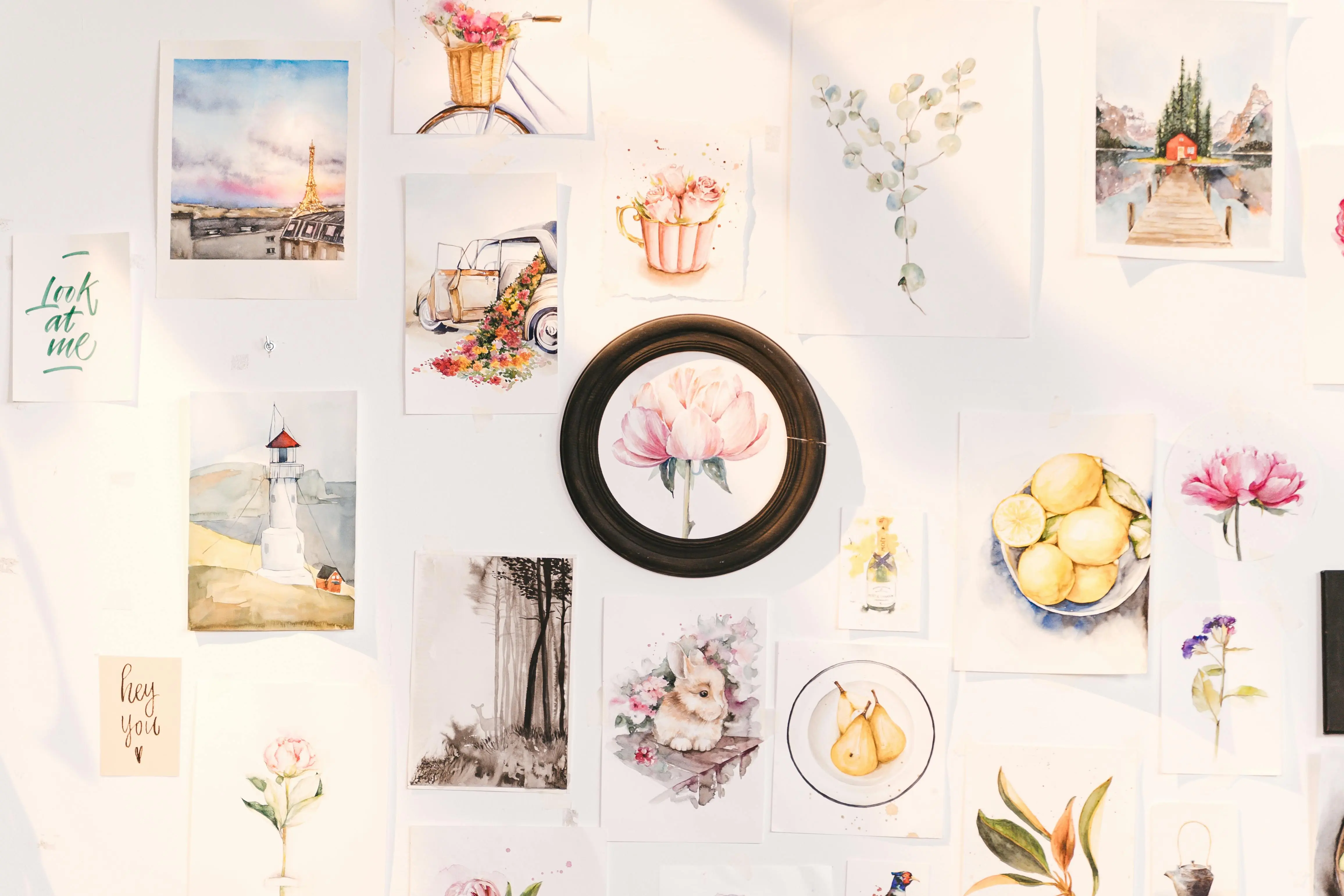 what to paint A vibrant collection of art prints showcasing flowers, landscapes, and creative designs on a wall.