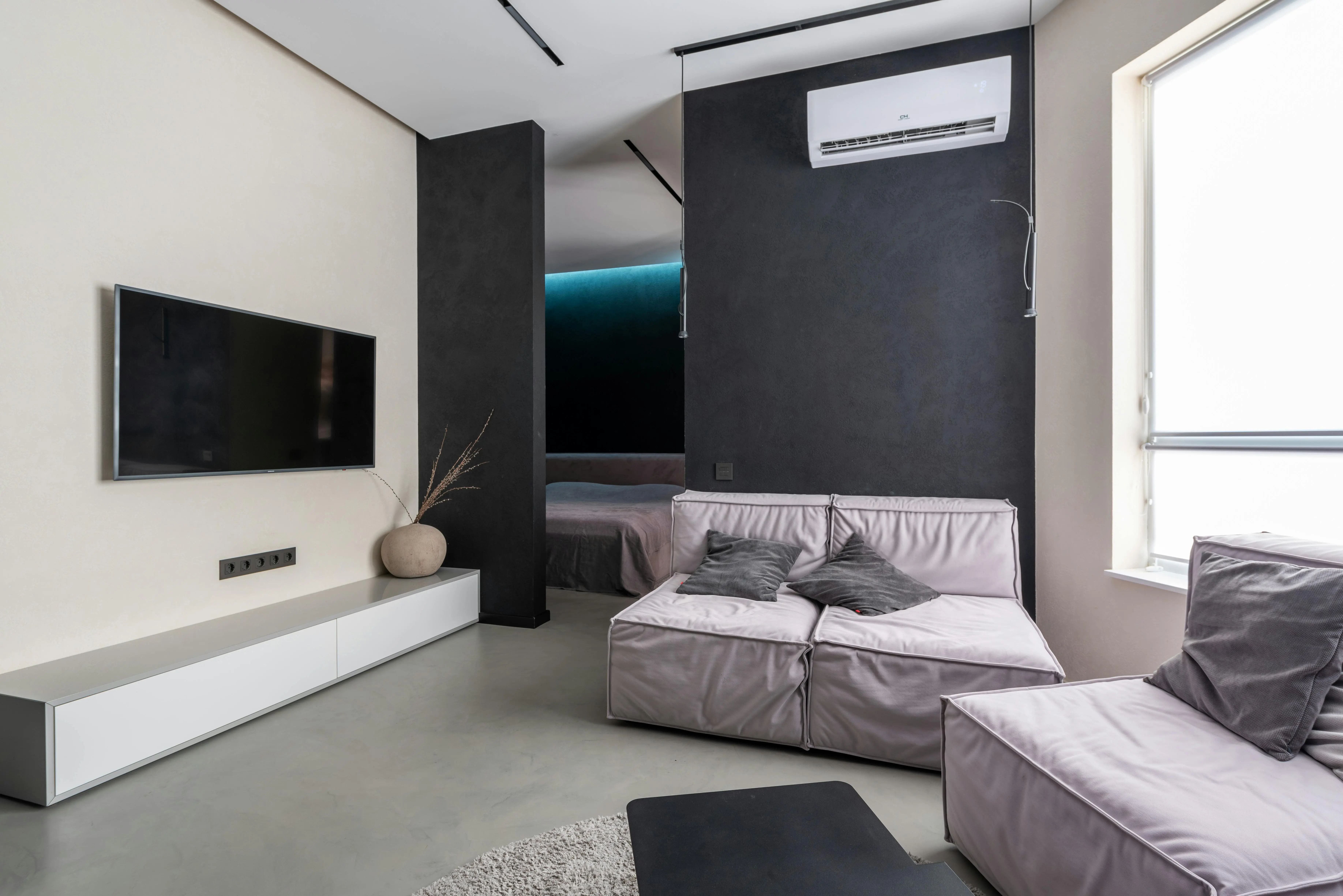 3 piece living room set Contemporary living room with sleek furniture, TV, and air conditioning in a modern apartment.