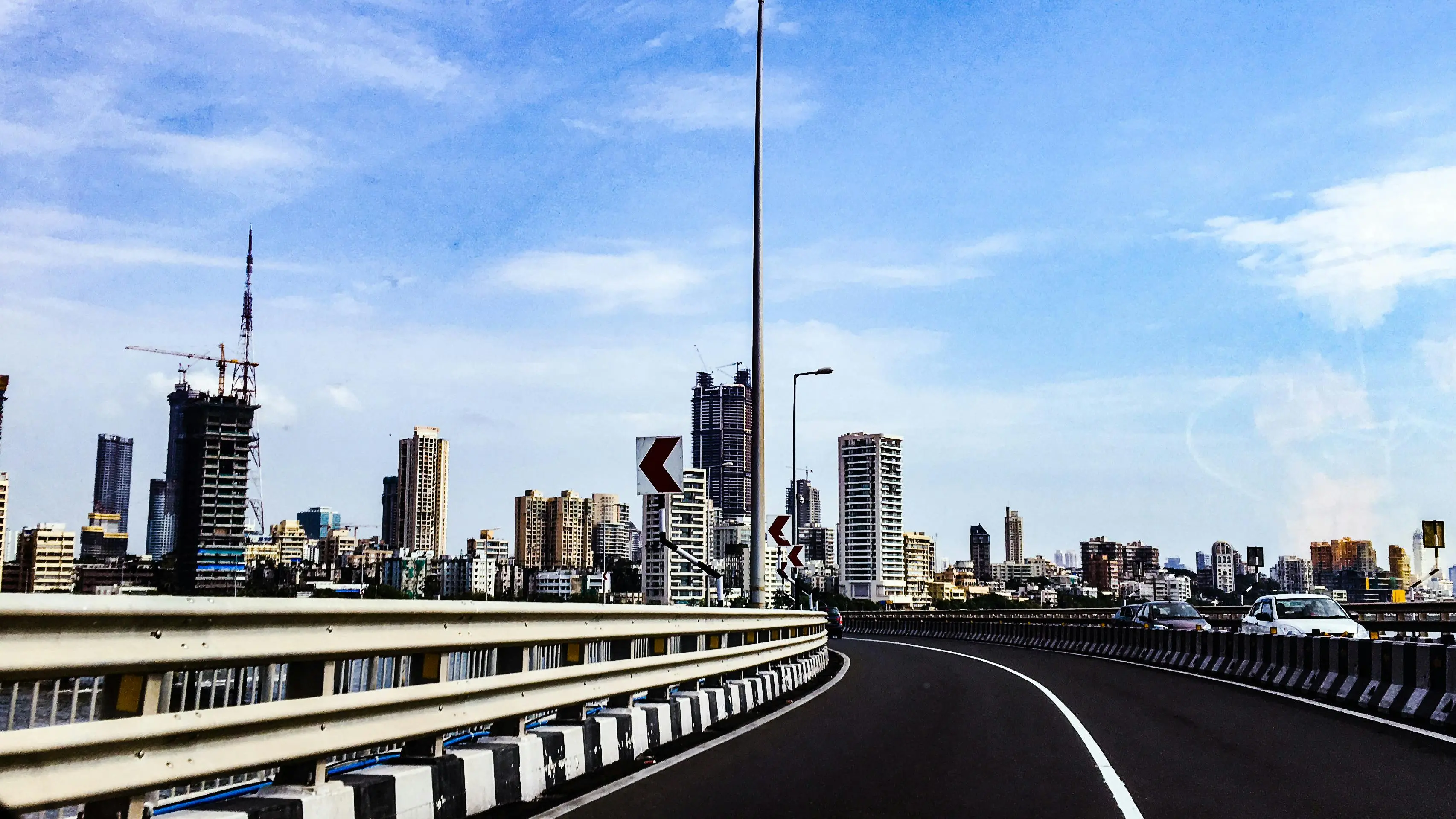 mouse bait View of Mumbai's skyline featuring modern skyscrapers and a highway.