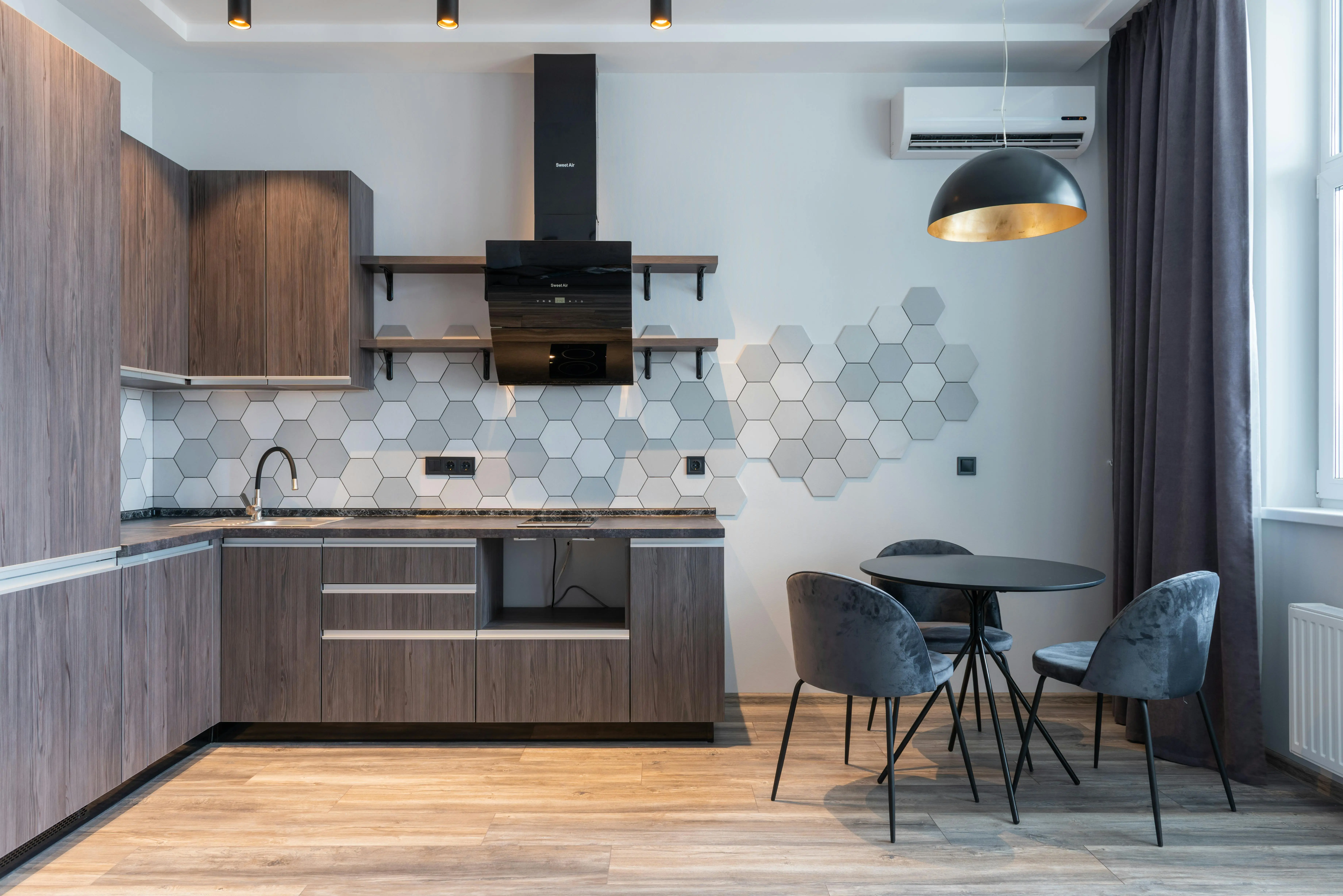 spanish tile Stylish modern kitchen featuring hexagonal tile backsplash and contemporary furniture.