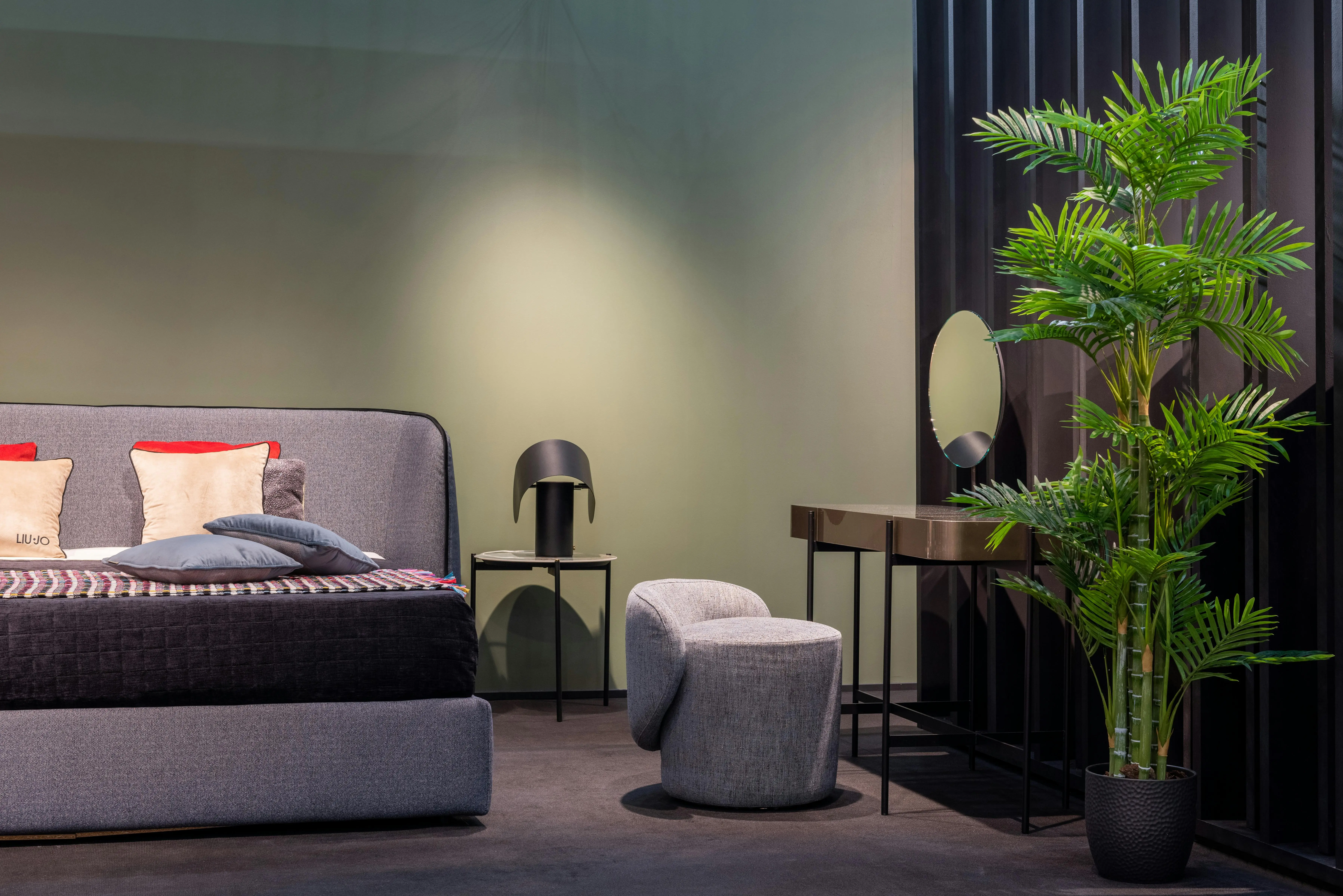 corner bed ideas Comfortable double bed with cushions placed near lamp on bedside with dressing table near potted plant