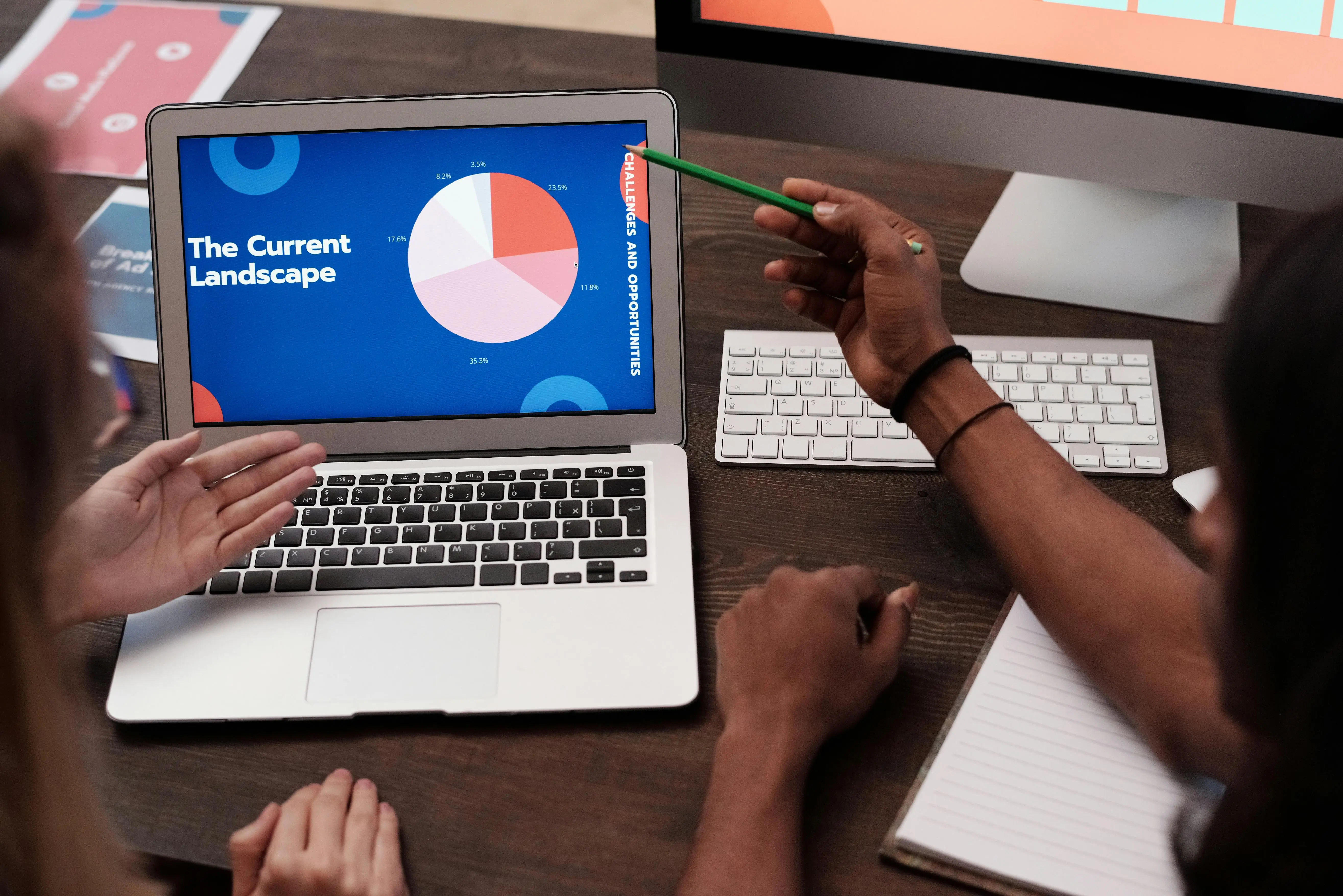 desk bed Team discussing data with graph on laptop screen in office setting.