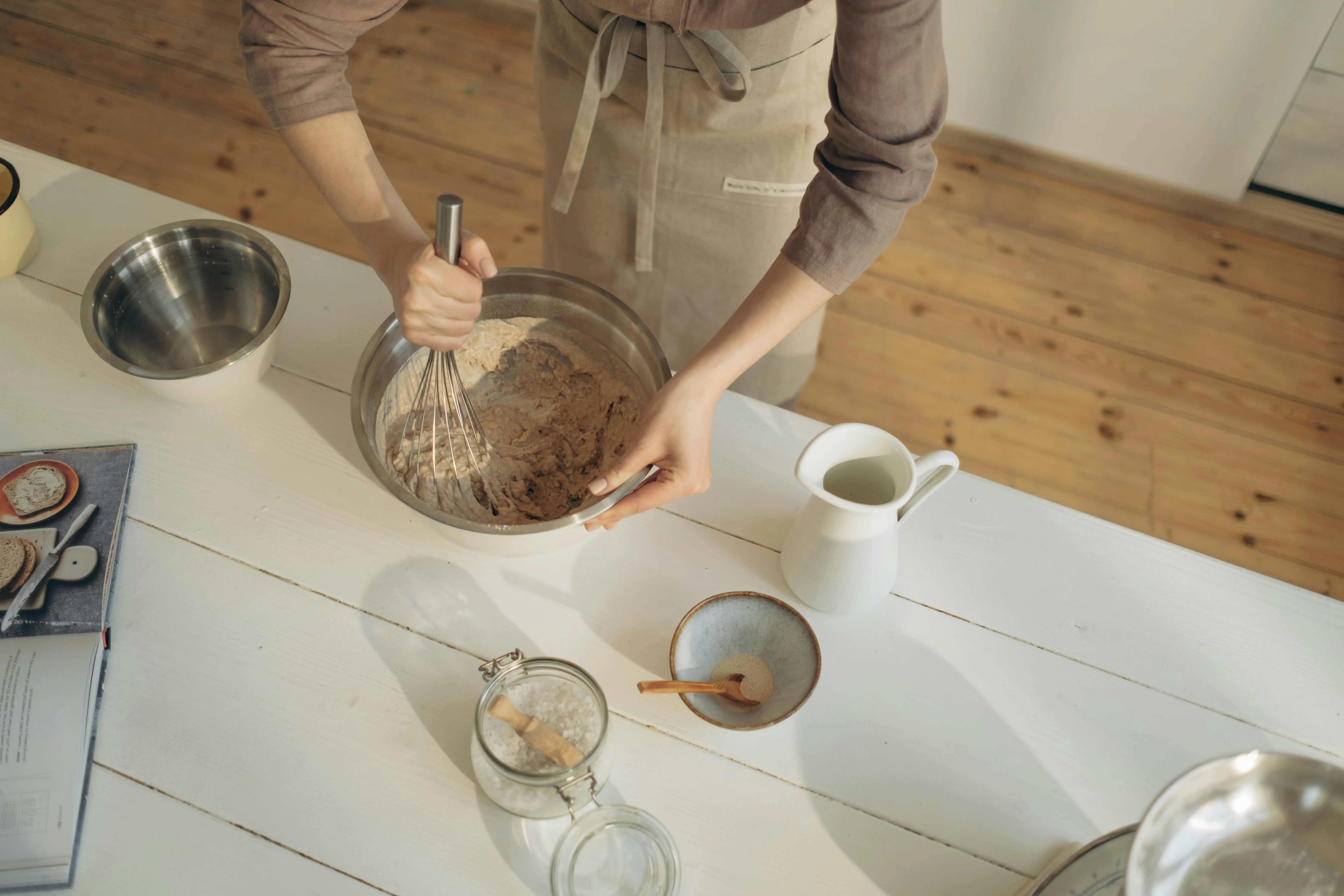epoxy garage floor coating diy A baker mixes ingredients in a bowl on a kitchen counter, captured from above for an artistic view.