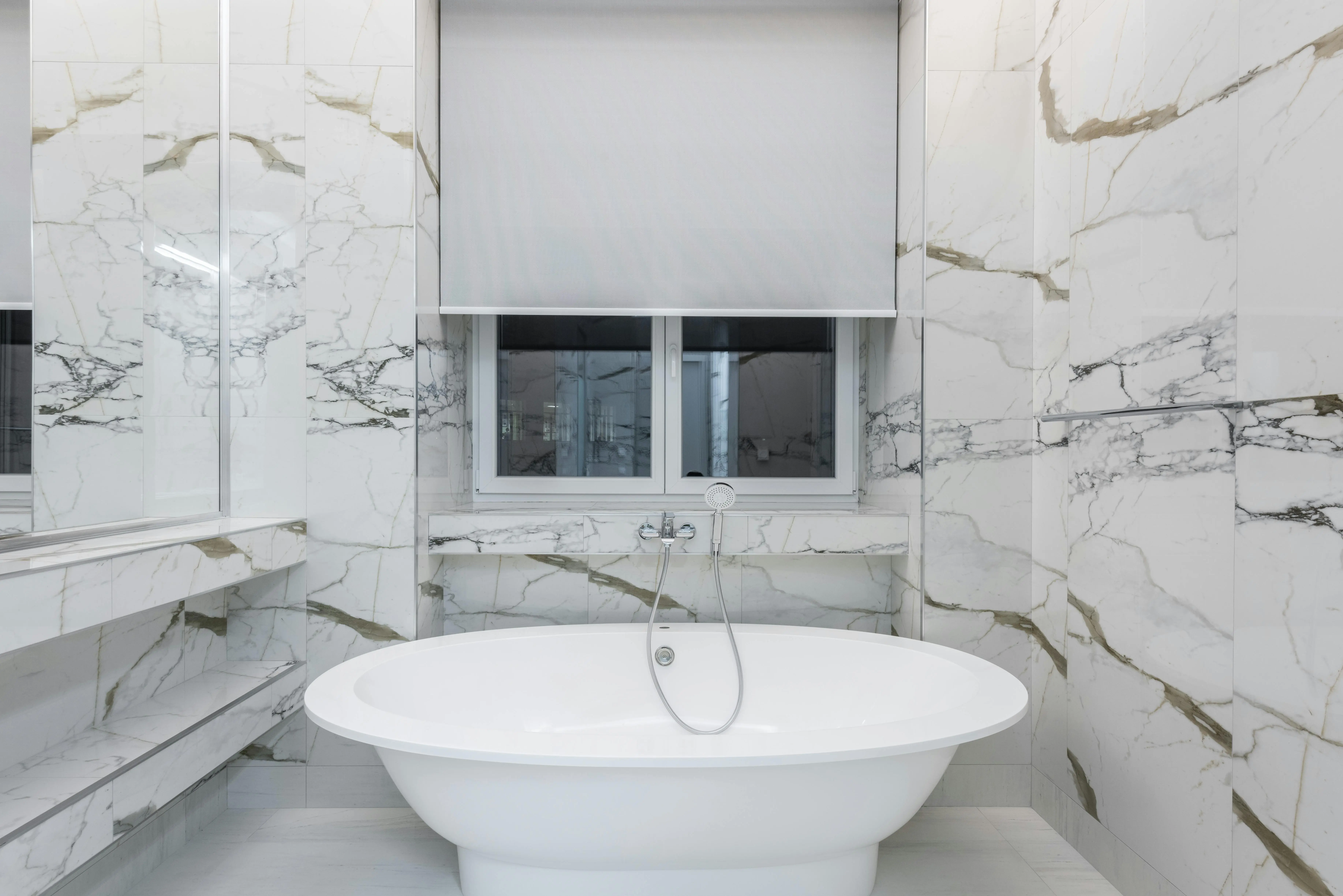 ideas for replacing a garden tub Modern bathroom featuring a luxurious marble design and a sleek freestanding bathtub.