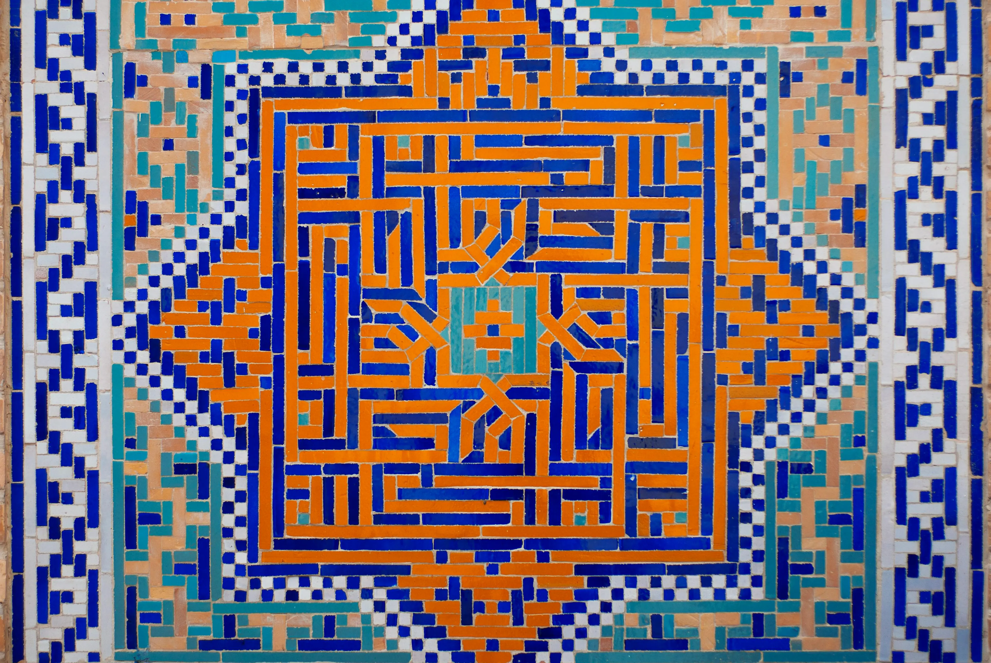 contemporary elegant tile styles Intricate Islamic geometric tile art in vibrant blue, orange, and teal colors.