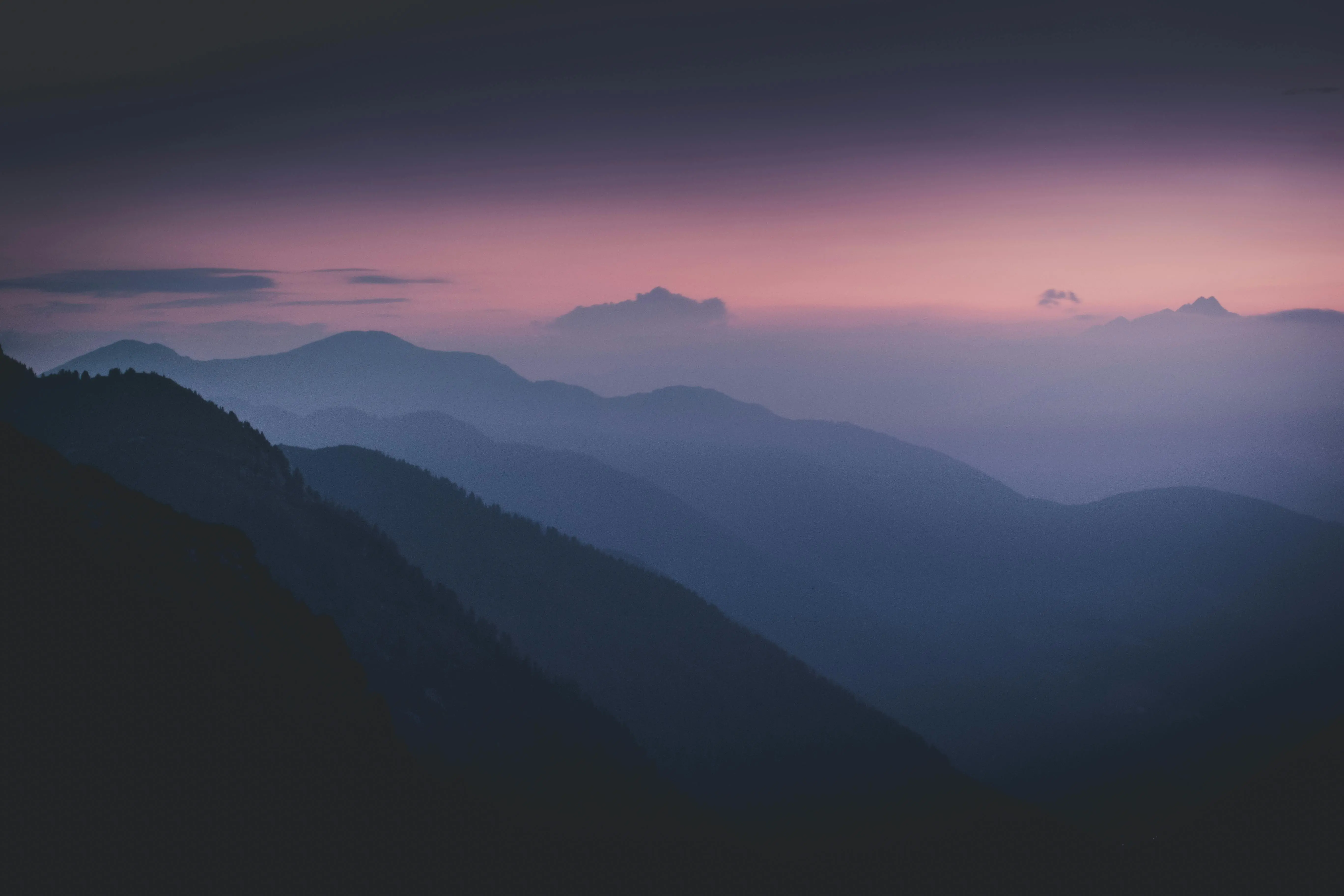 what to paint Serene misty mountain range silhouetted against a twilight sky.