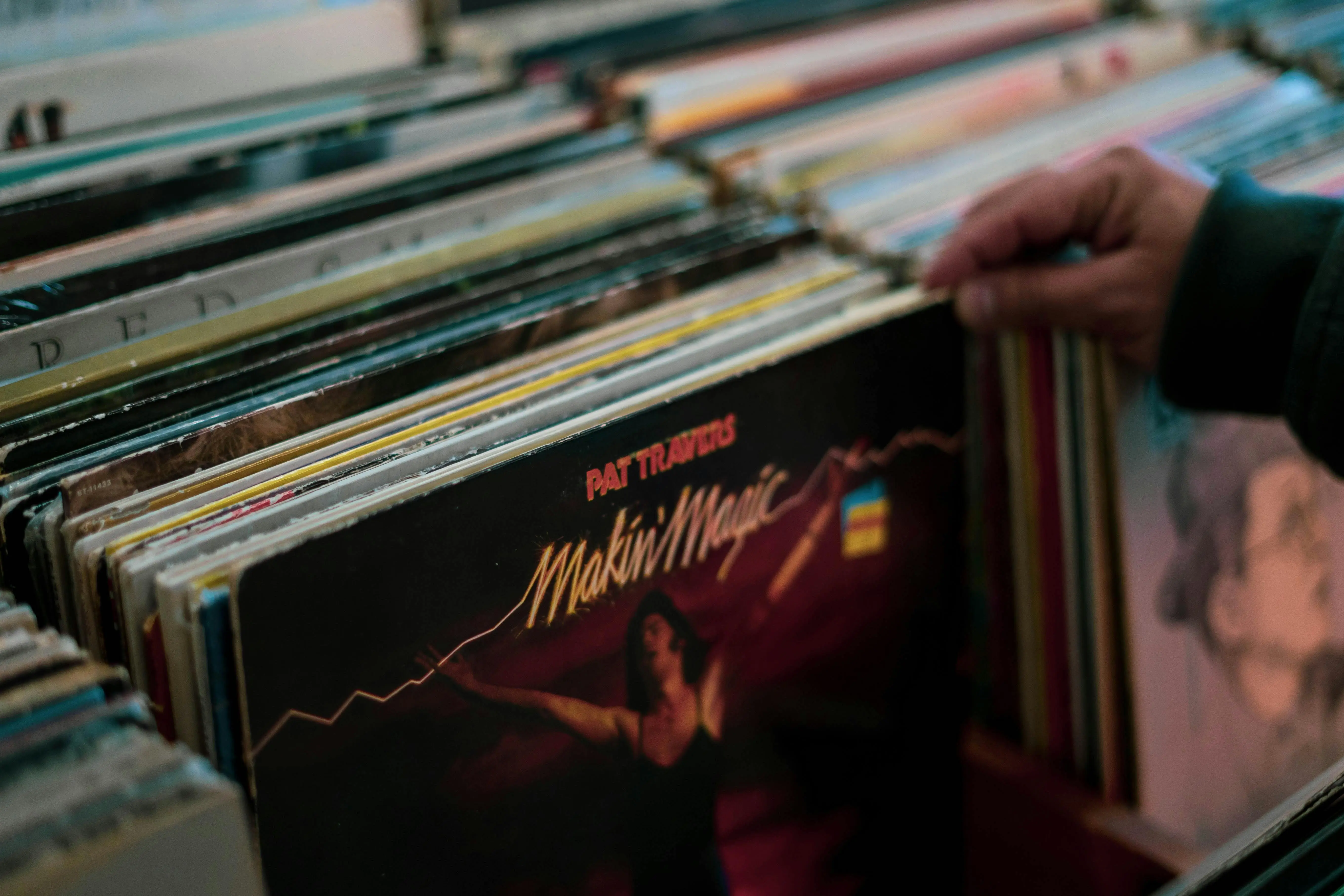 record storage cabinet Person browsing vinyl records collection in a Cambridge store. Nostalgic and retro vibe.