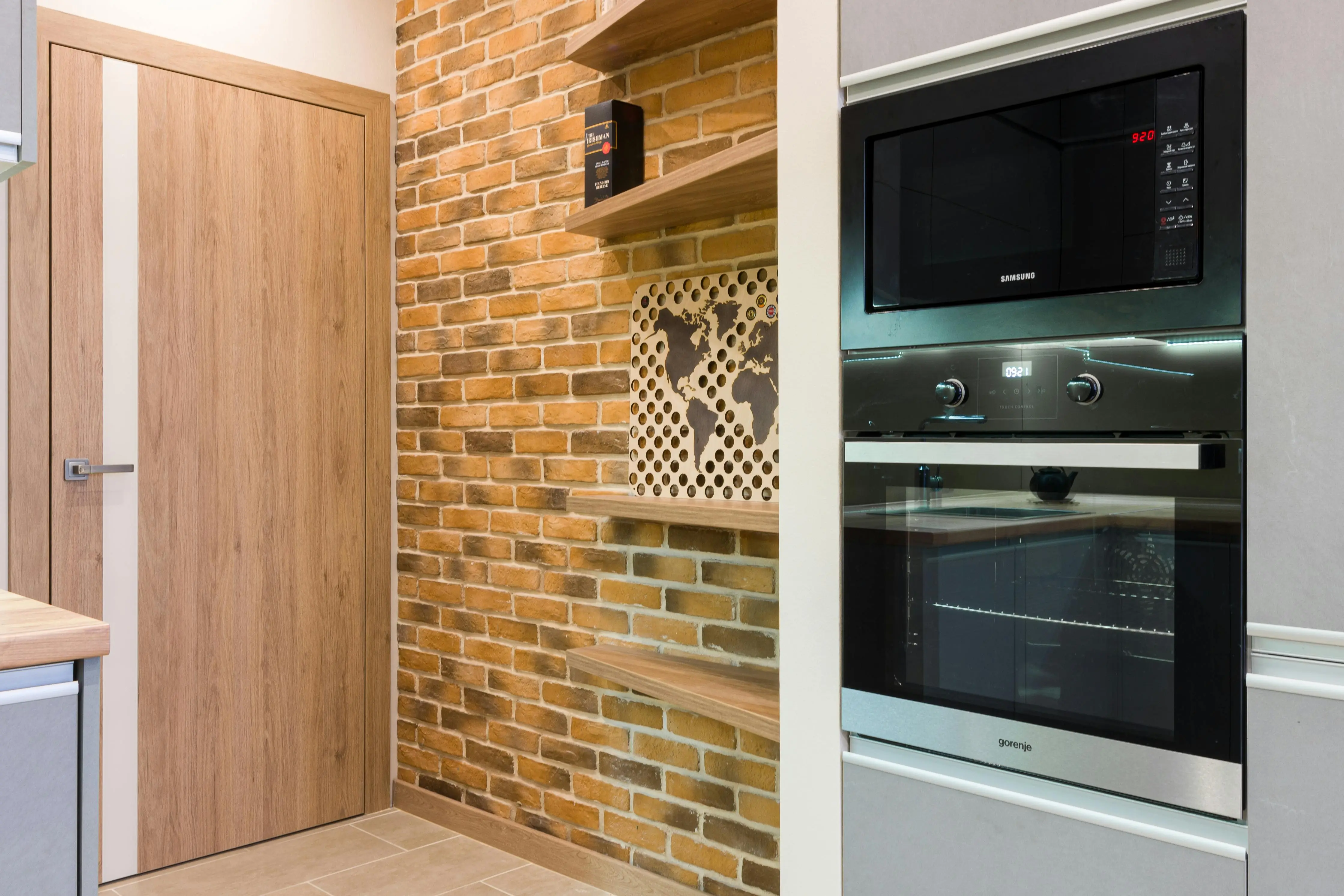 desk bed Stylish interior kitchen featuring a brick wall and modern appliances.