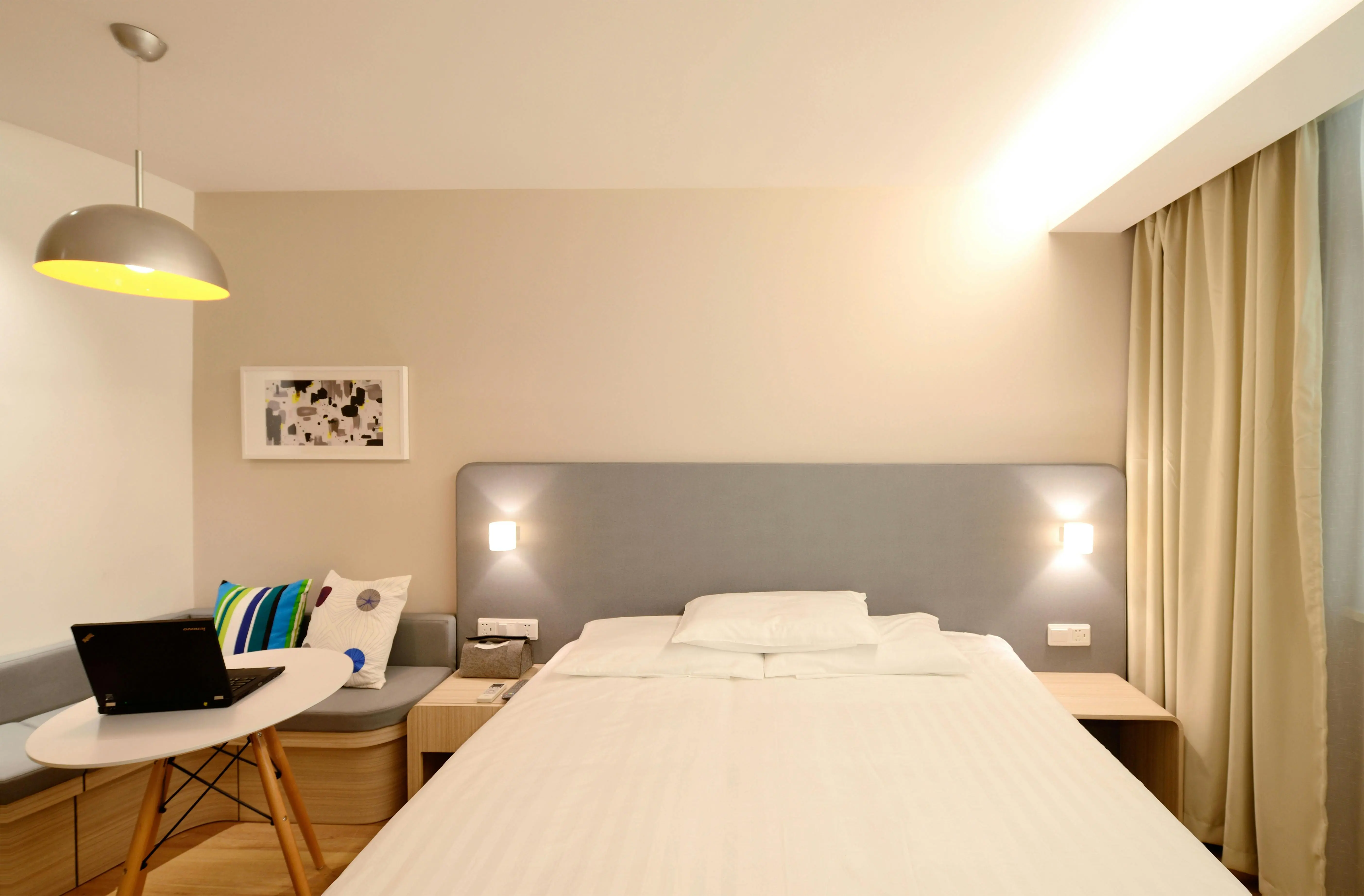 corner bed ideas Contemporary hotel room with minimalist interior design and cozy lighting.