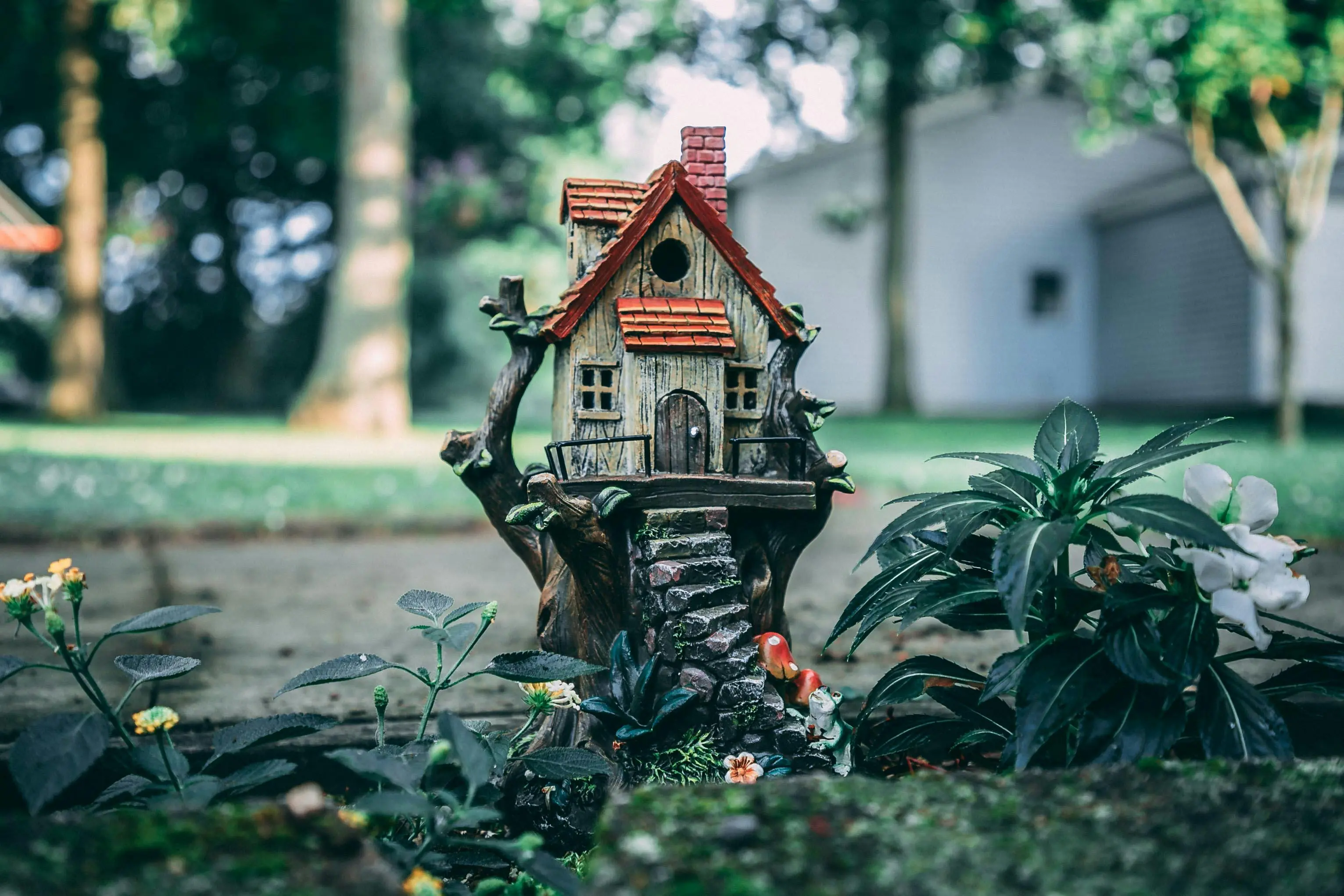 3 bedroom tiny house A whimsical miniature house set amidst a lush fairy garden, evoking a sense of enchantment and fantasy.