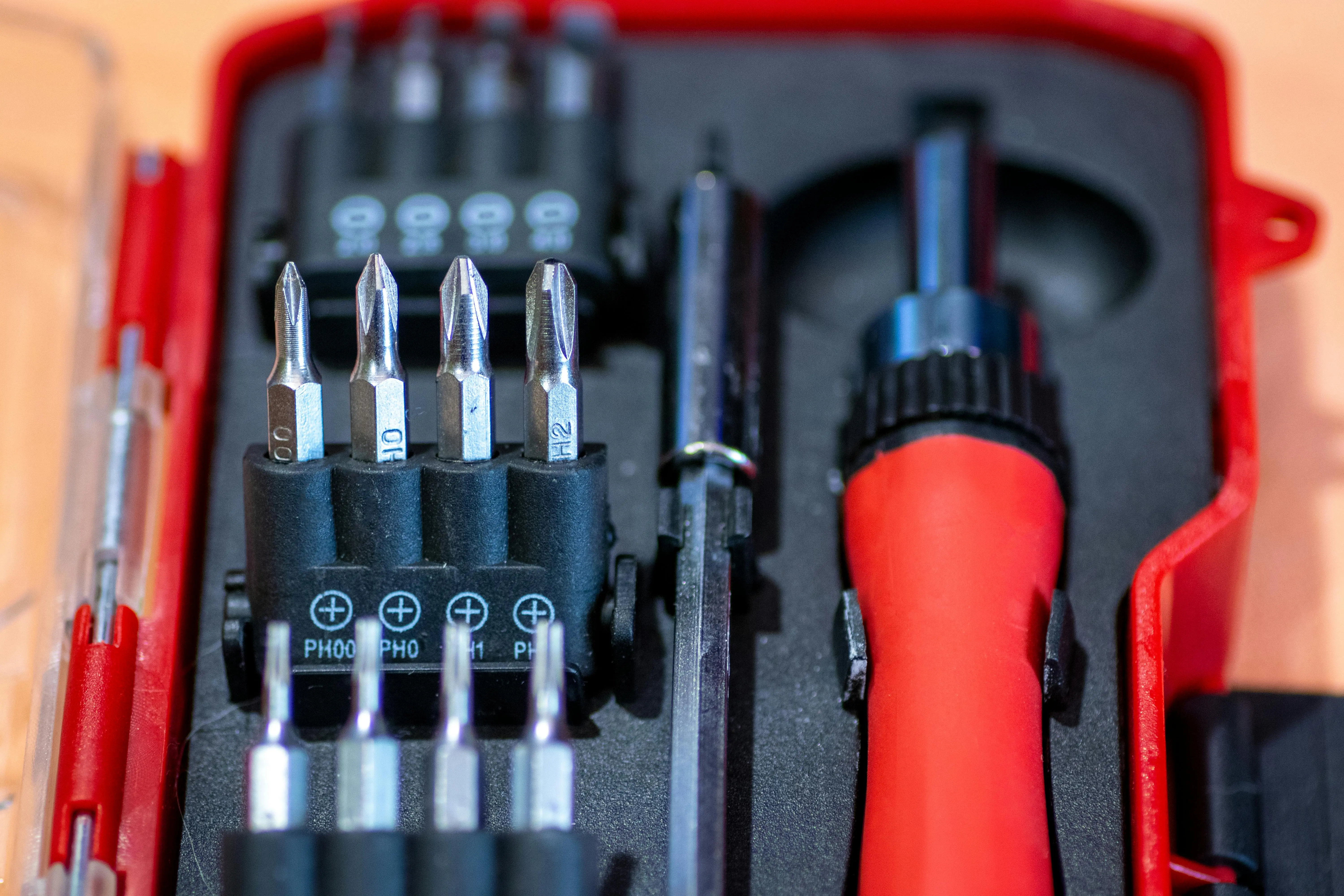 diy tool box Detailed view of a screwdriver set in a red case, featuring interchangeable bits and tools.