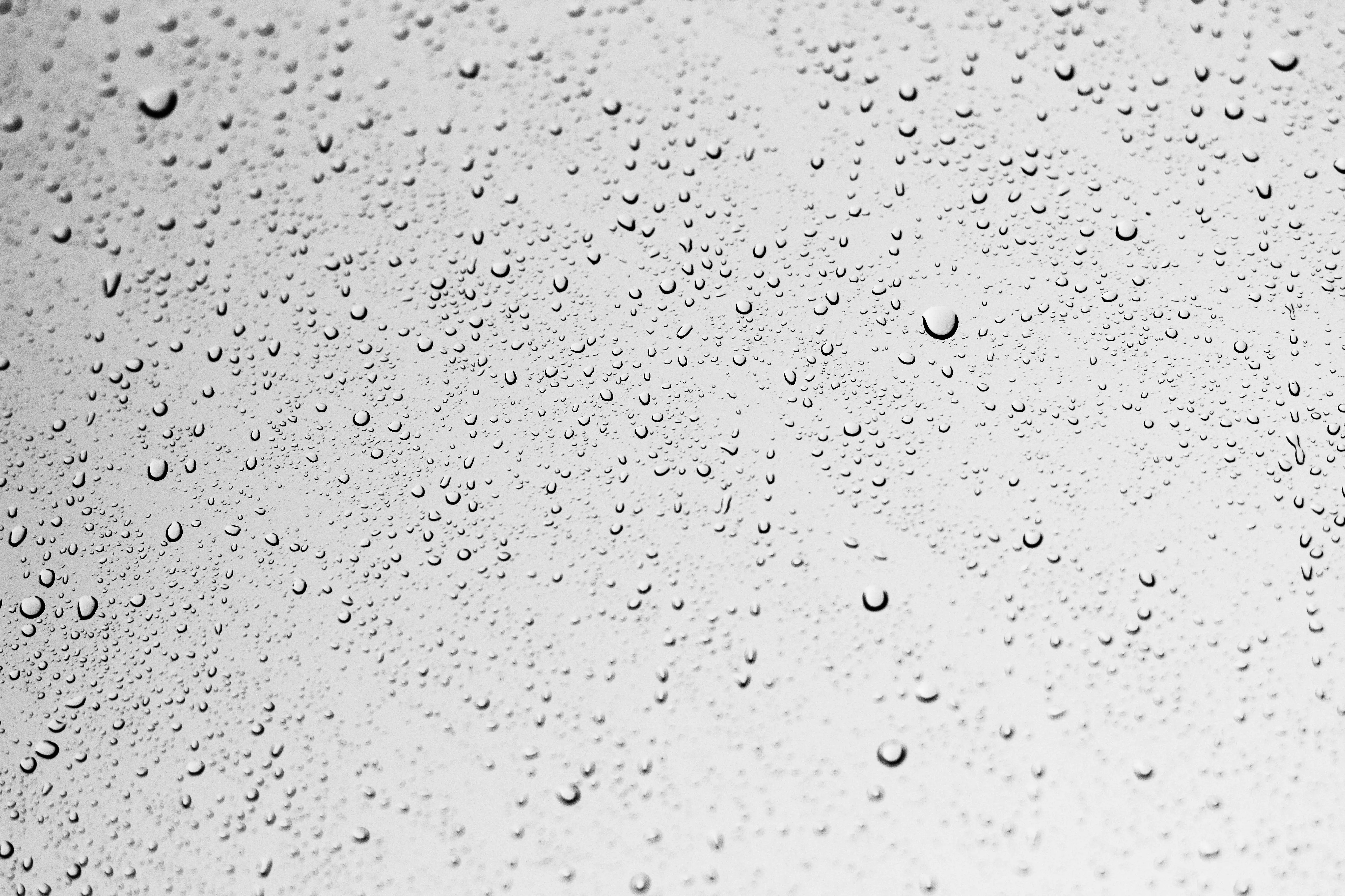 how to get pee smell out of clothes Macro shot of water droplets on a grey surface creating an abstract texture.