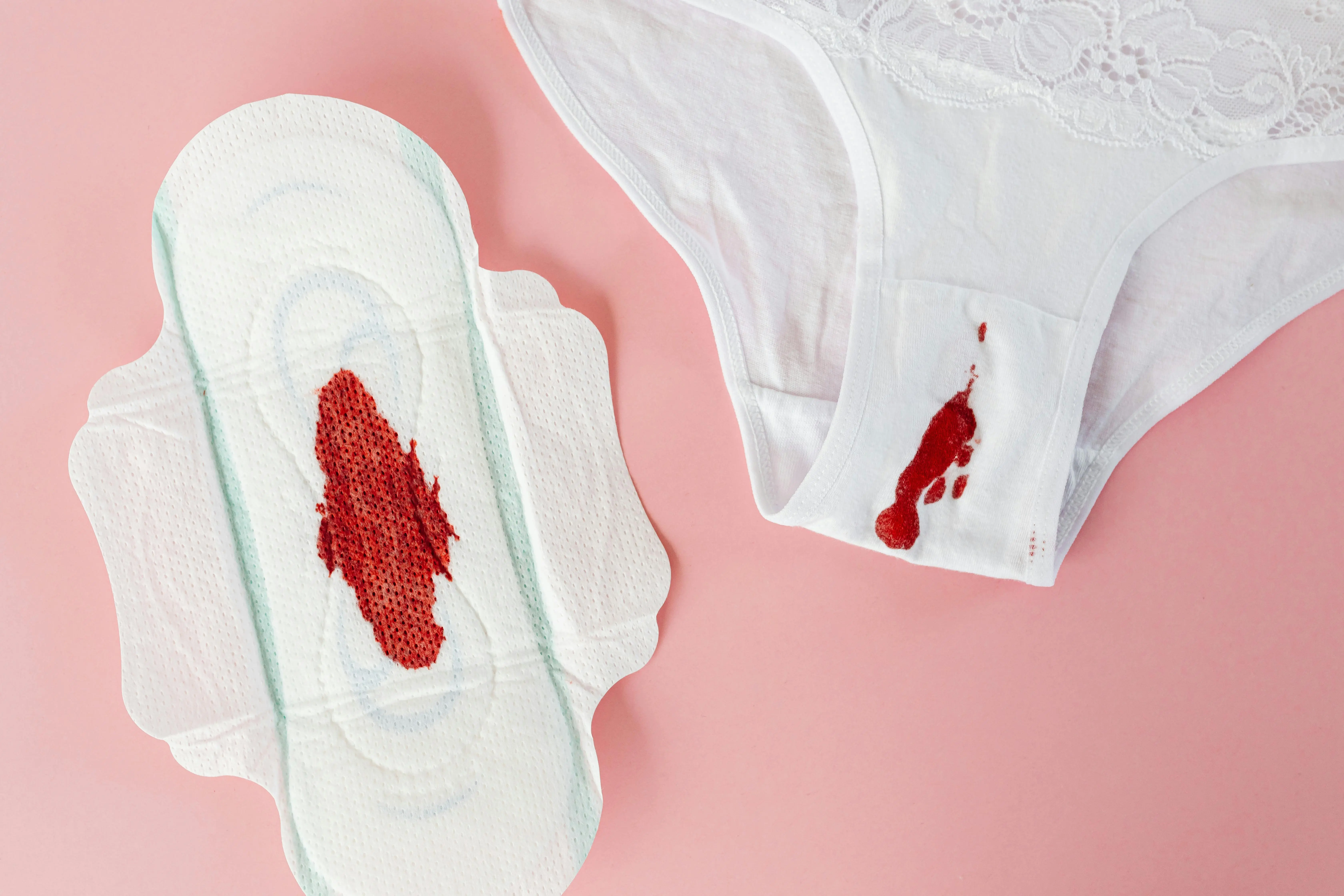 how to get deodorant stains out of black shirts Close-up of white panty and sanitary pad with menstrual blood on pink background.