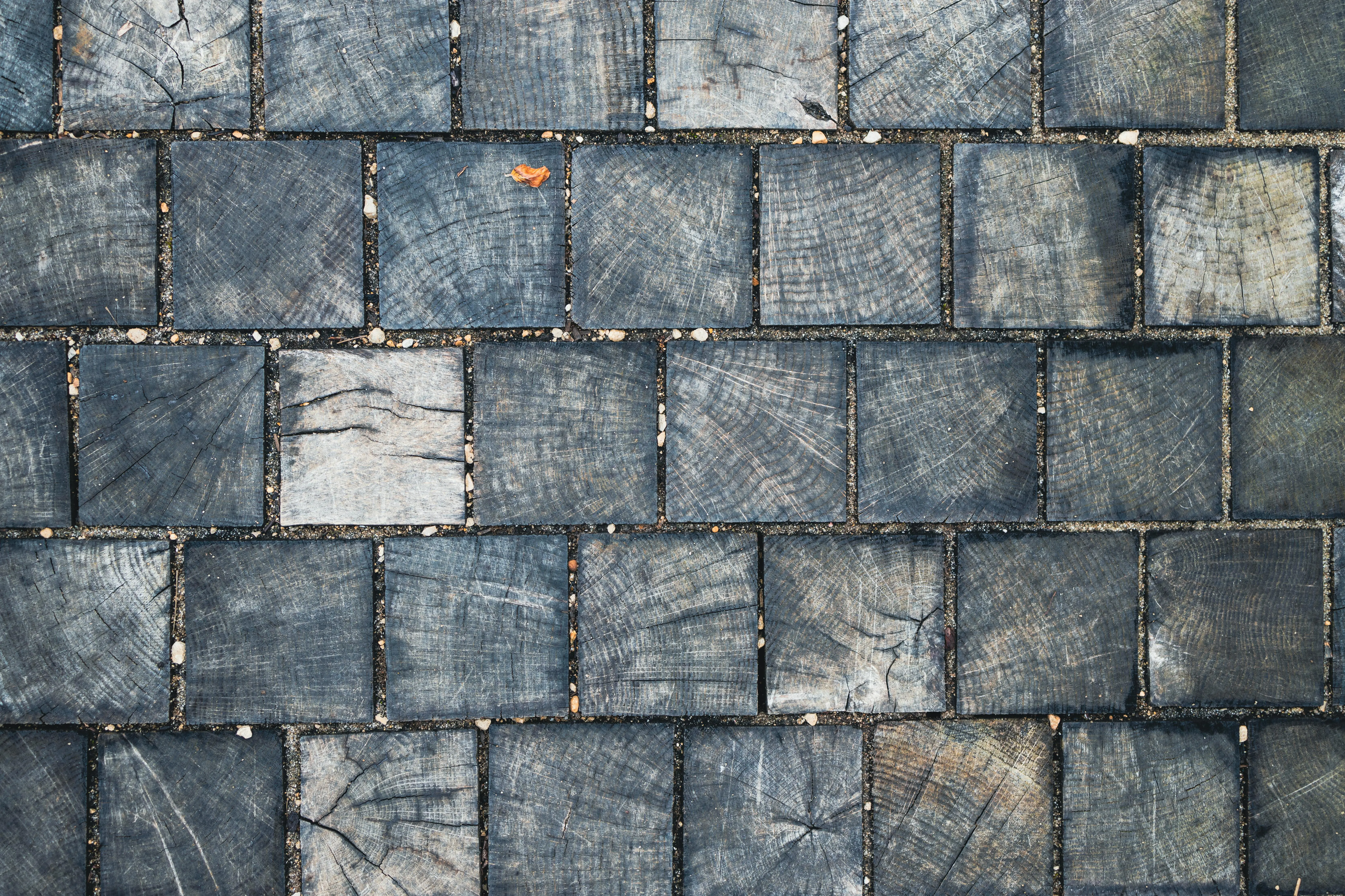 contemporary elegant tile styles Top view of rustic wooden tiles forming an abstract geometric pattern.