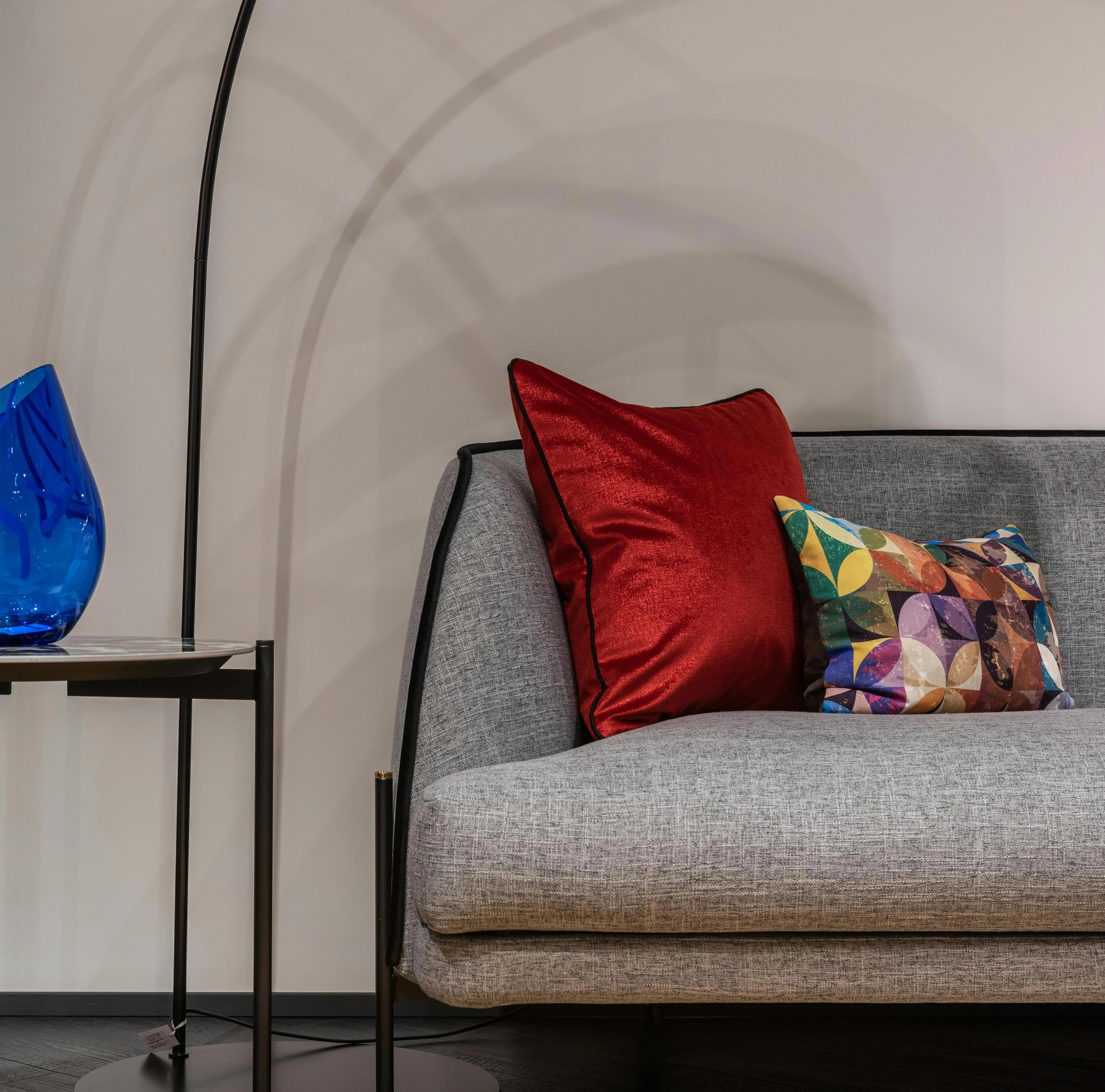 blue pillows Stylish living room showcasing a modern gray sofa with colorful pillows and a decorative blue vase.