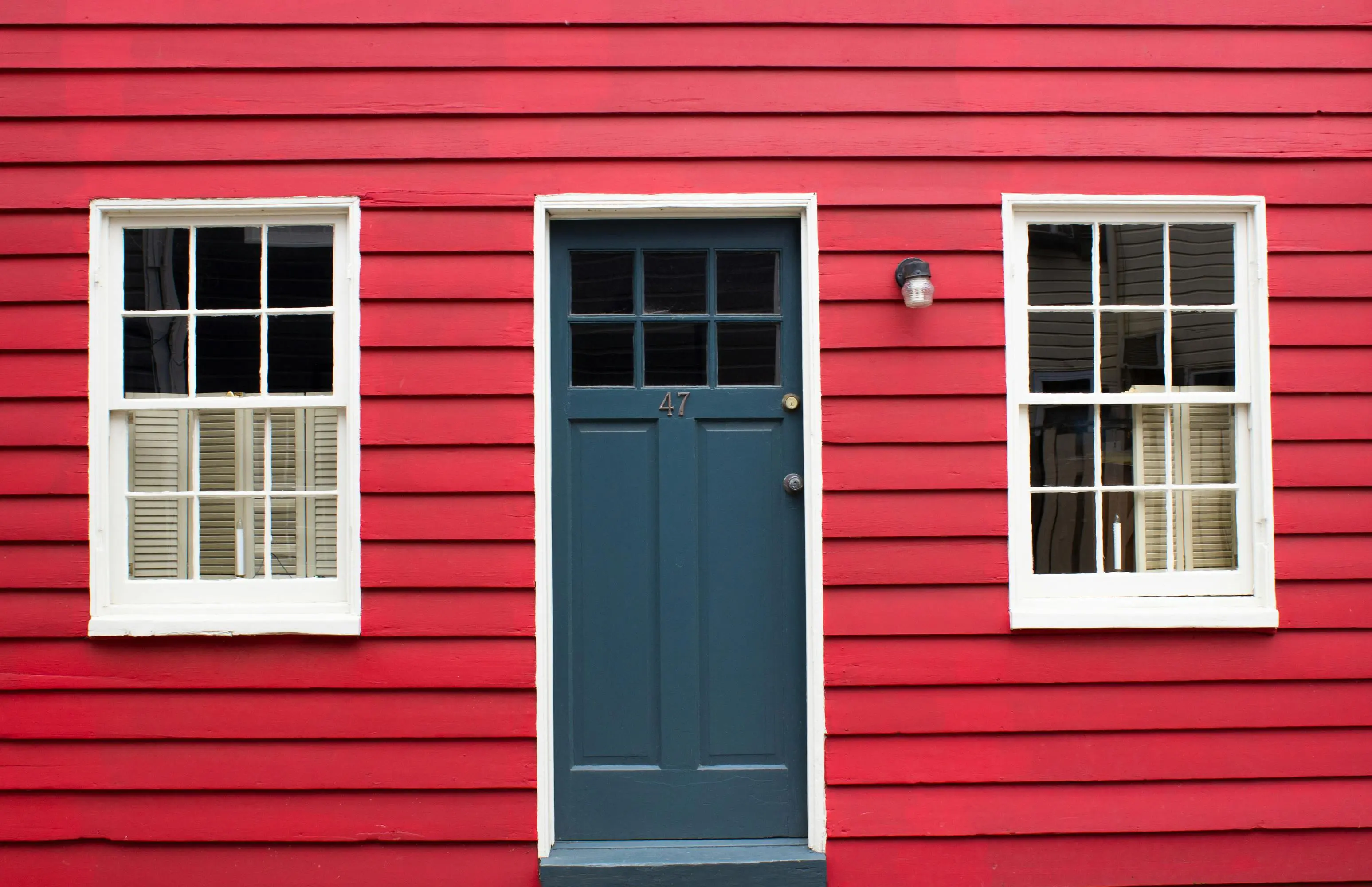 dark blue siding colors Classic red house with a blue door in Annapolis, MD.