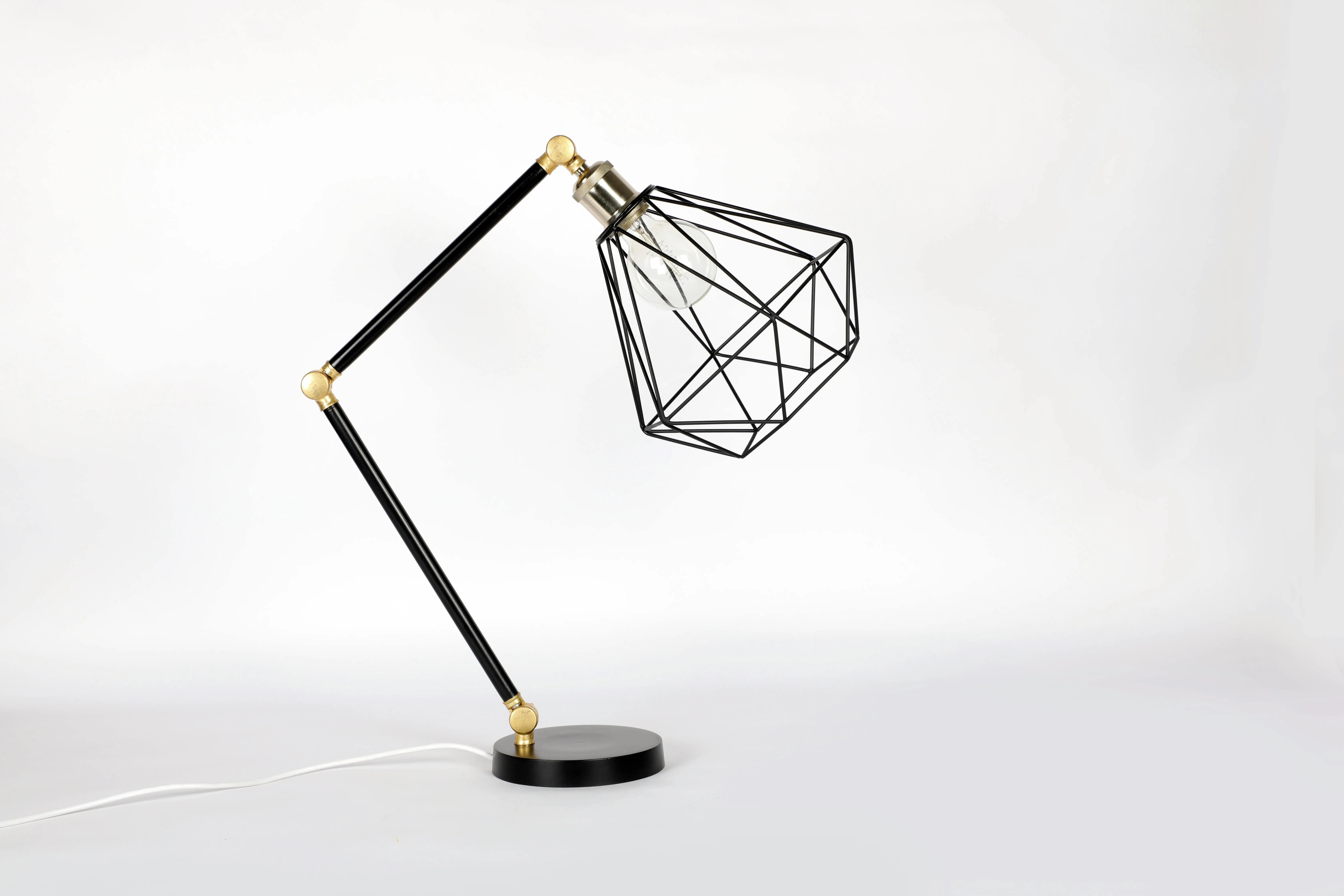 beach chandelier Minimalist geometric metal table lamp with adjustable design on a white backdrop.