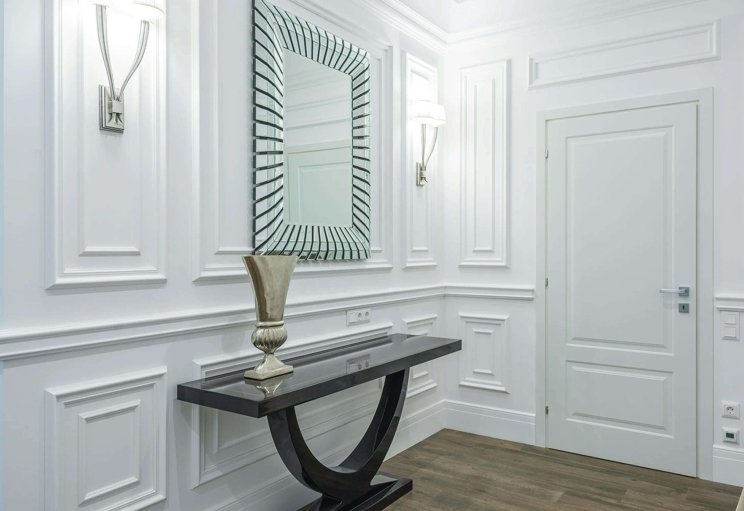 console to dining table A stylish hallway interior with modern decor, featuring a sleek mirror and elegant console table.