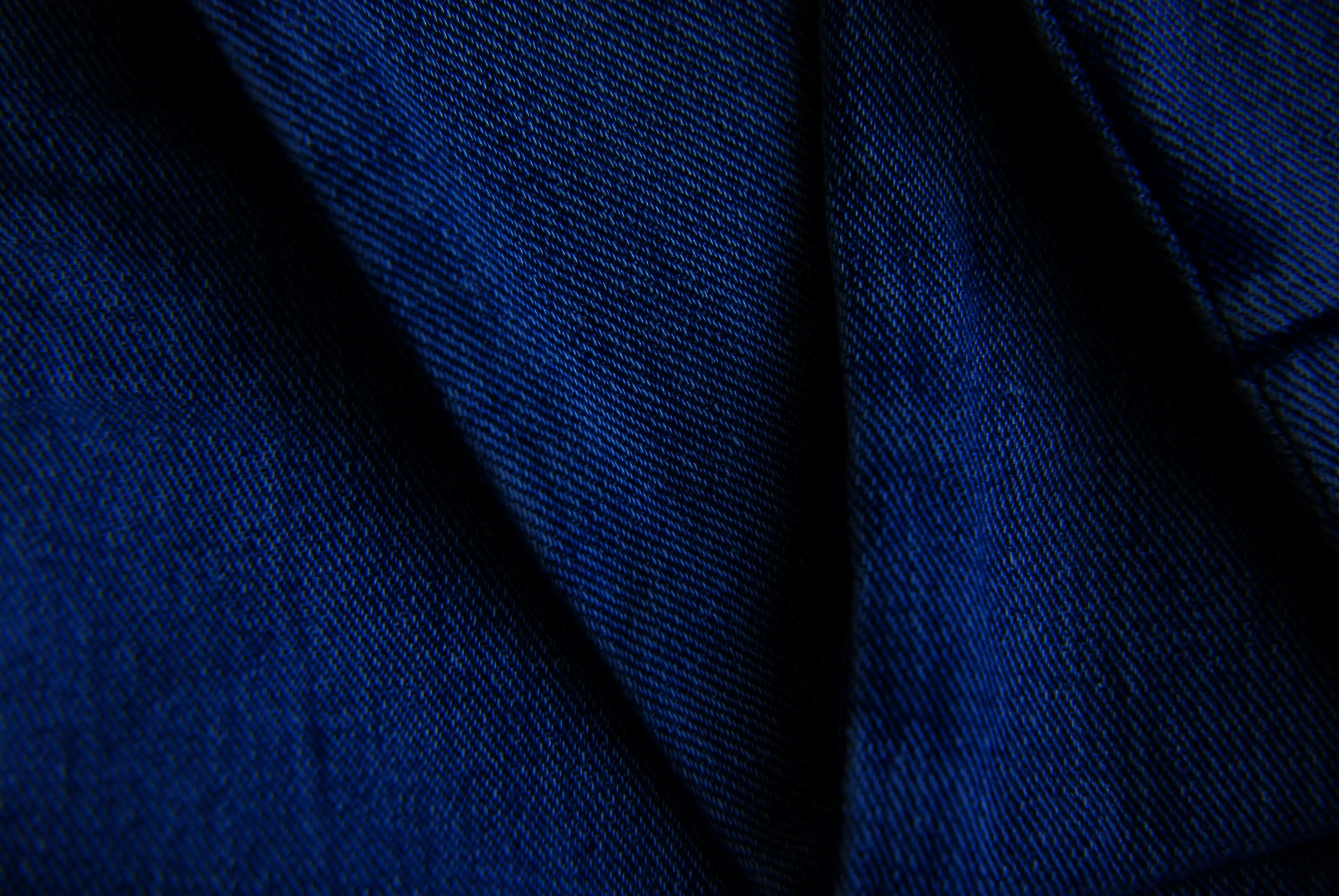 how to wash 100 cotton Detailed close-up of blue denim fabric showcasing texture and pattern.