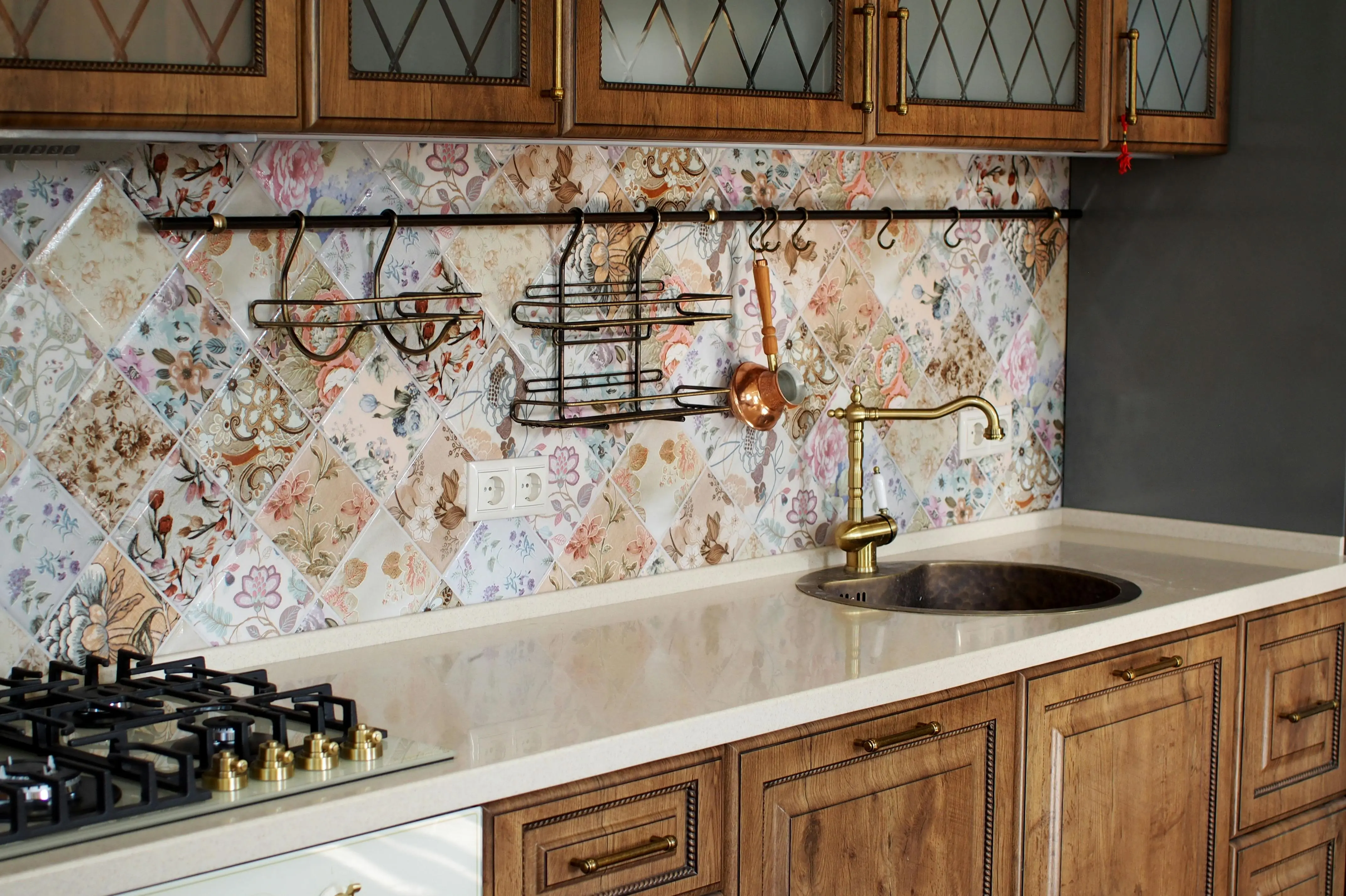 floral tiles Elegant kitchen interior featuring wooden cabinets and a floral tile backsplash.