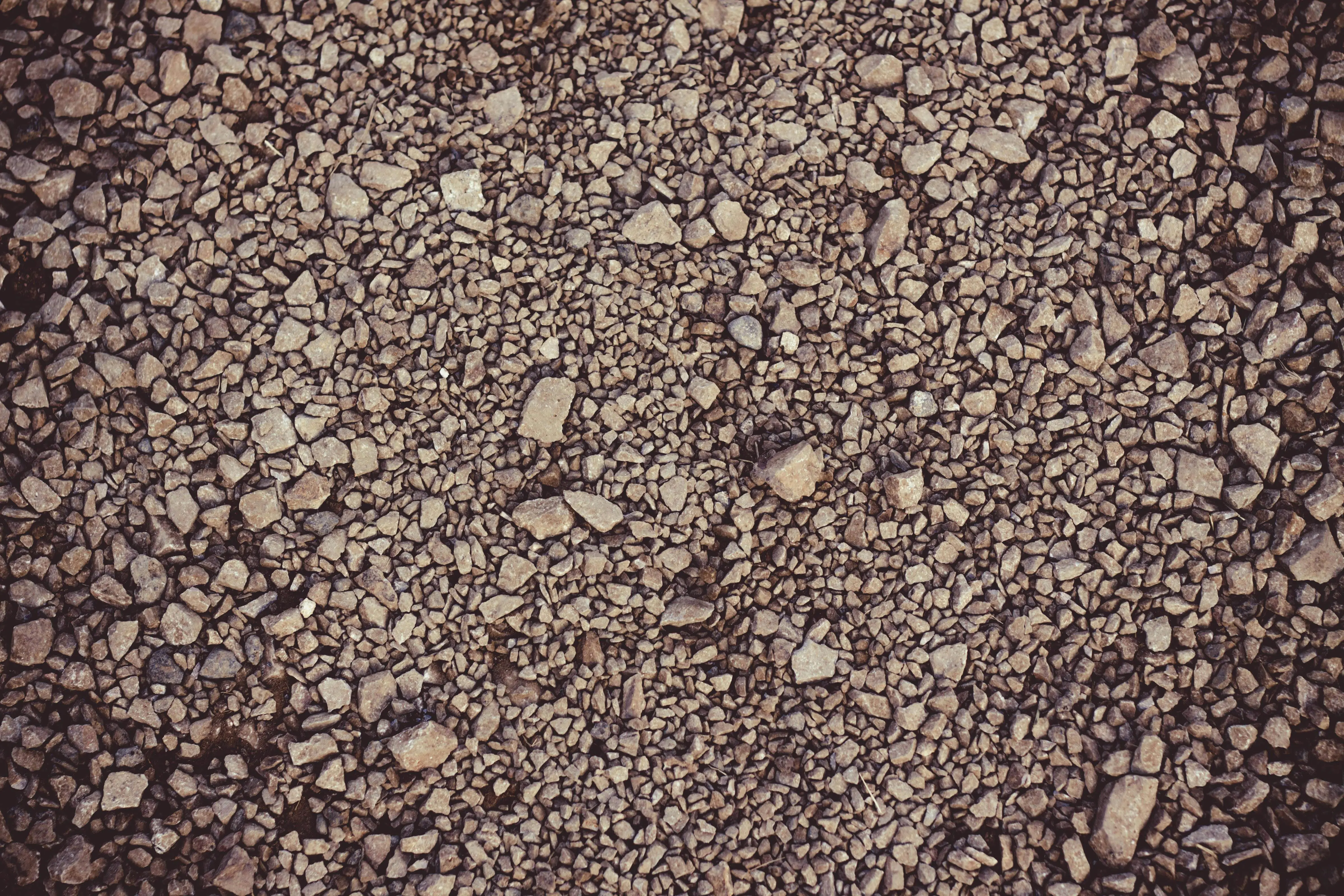 what to put around foundation of house Detailed gravel surface texture, perfect for backgrounds in design projects.