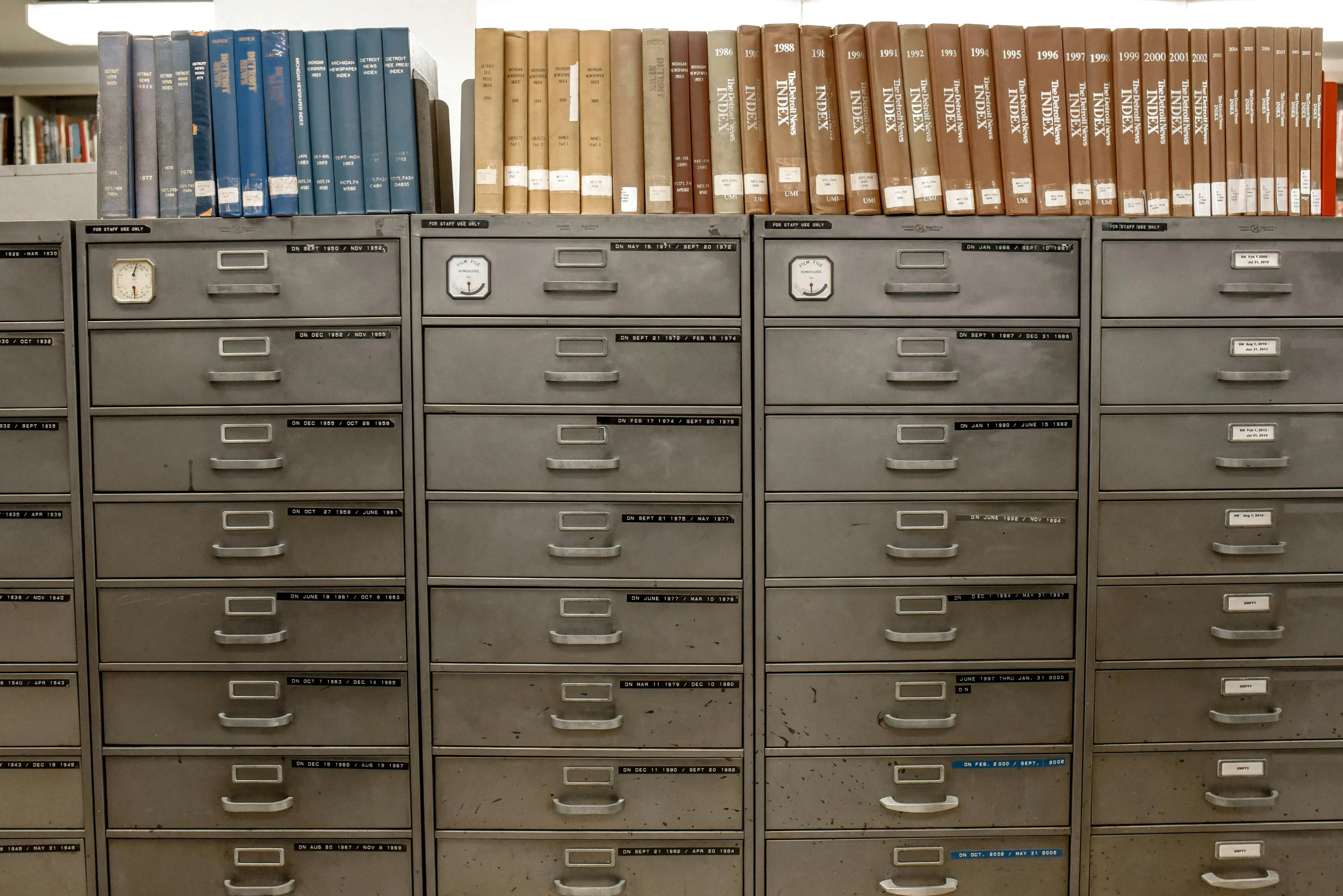 vanity drawer organizer Organized filing cabinets stacked with indexed books in a library setting.