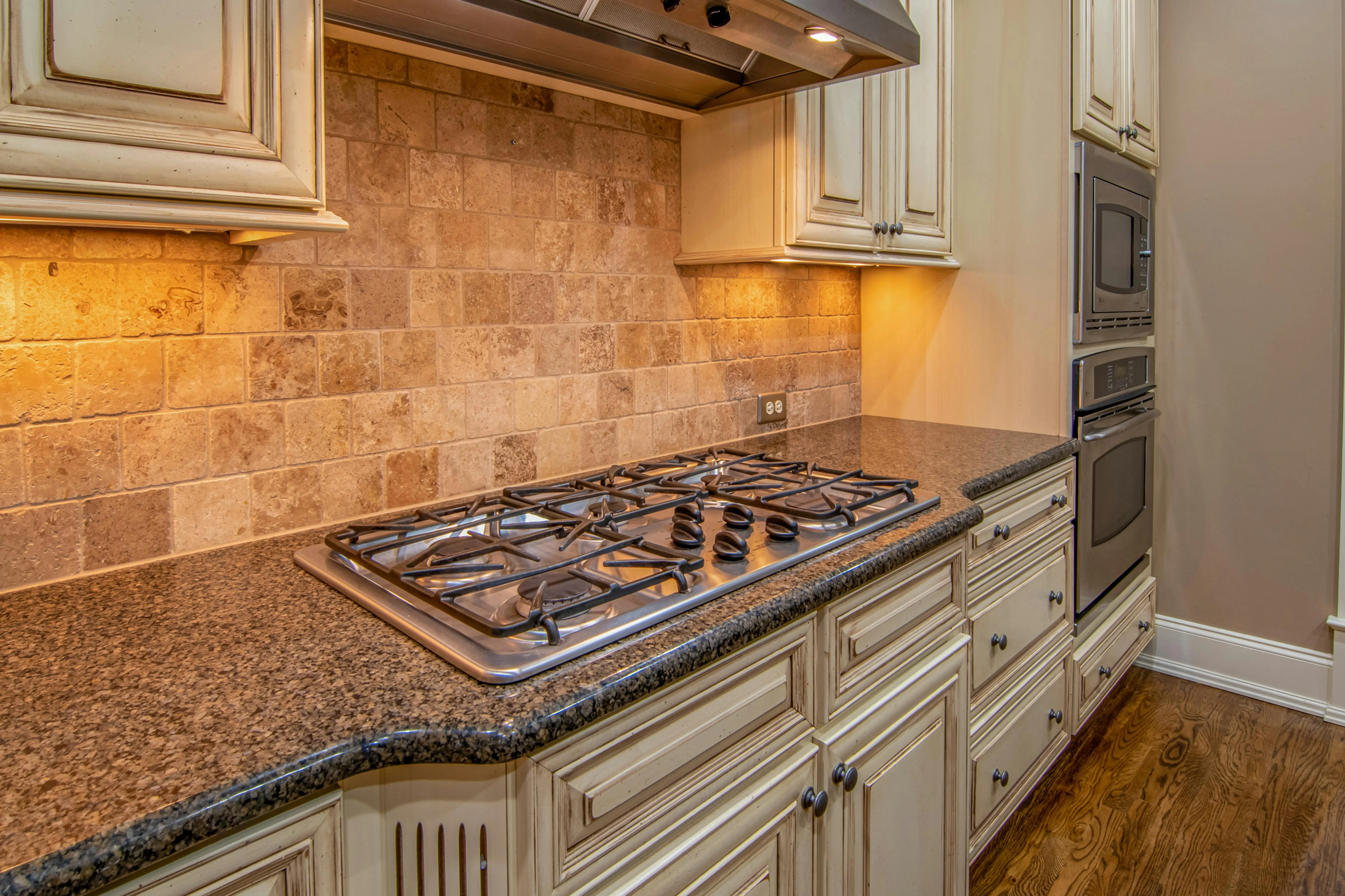 grey granite countertops colors Elegant kitchen featuring granite countertops and stainless steel appliances.