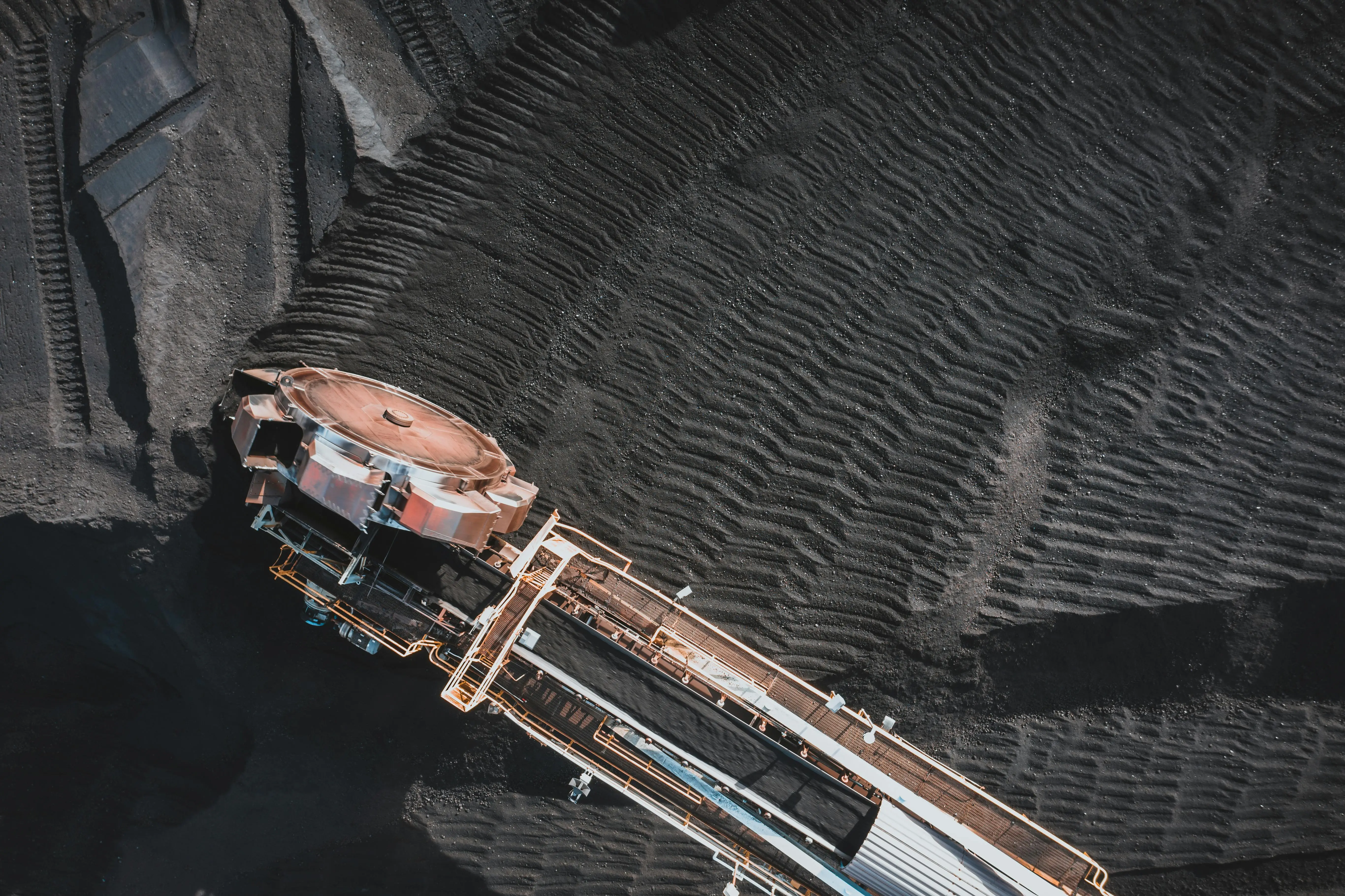 adjustable height coffee dining table Aerial view of an industrial conveyor system at a coal mining site, showcasing engineering and machinery.