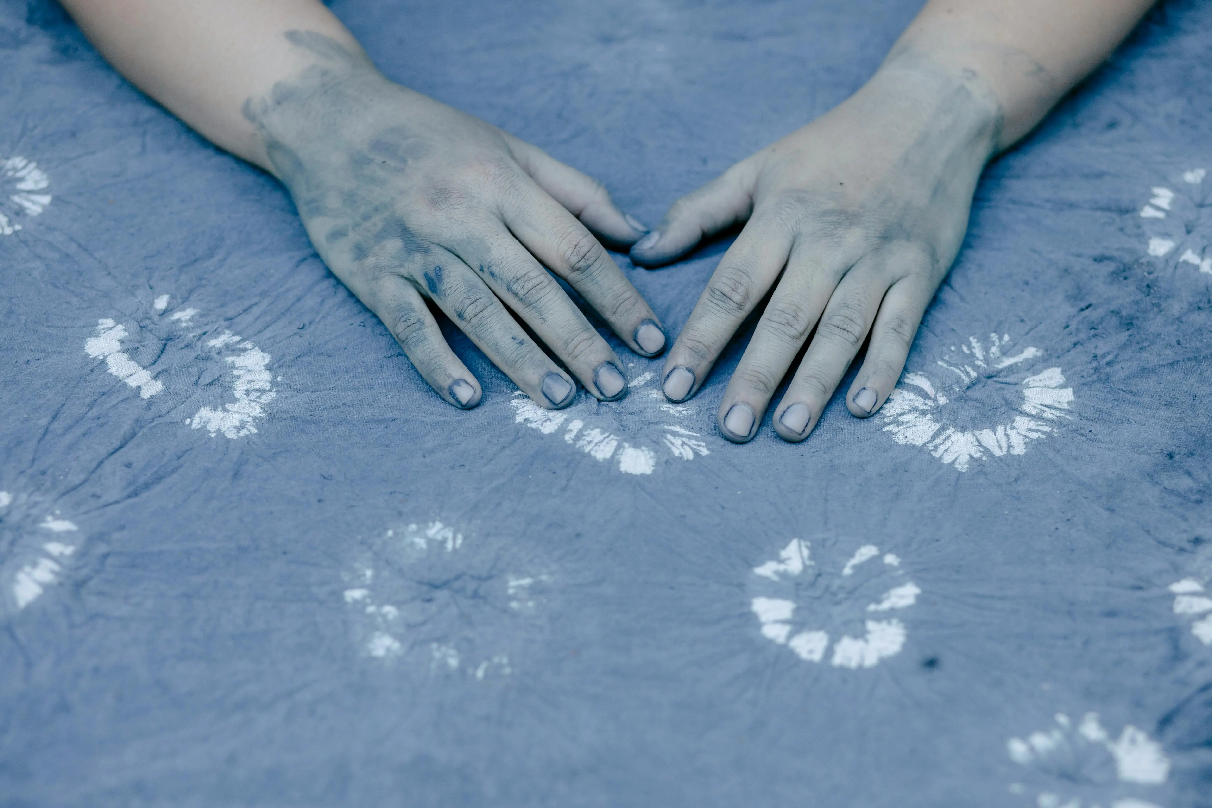 tie dye shirts for men High angle of crop anonymous female seamstress with painted crumpled fabric prepared for sewing clothes