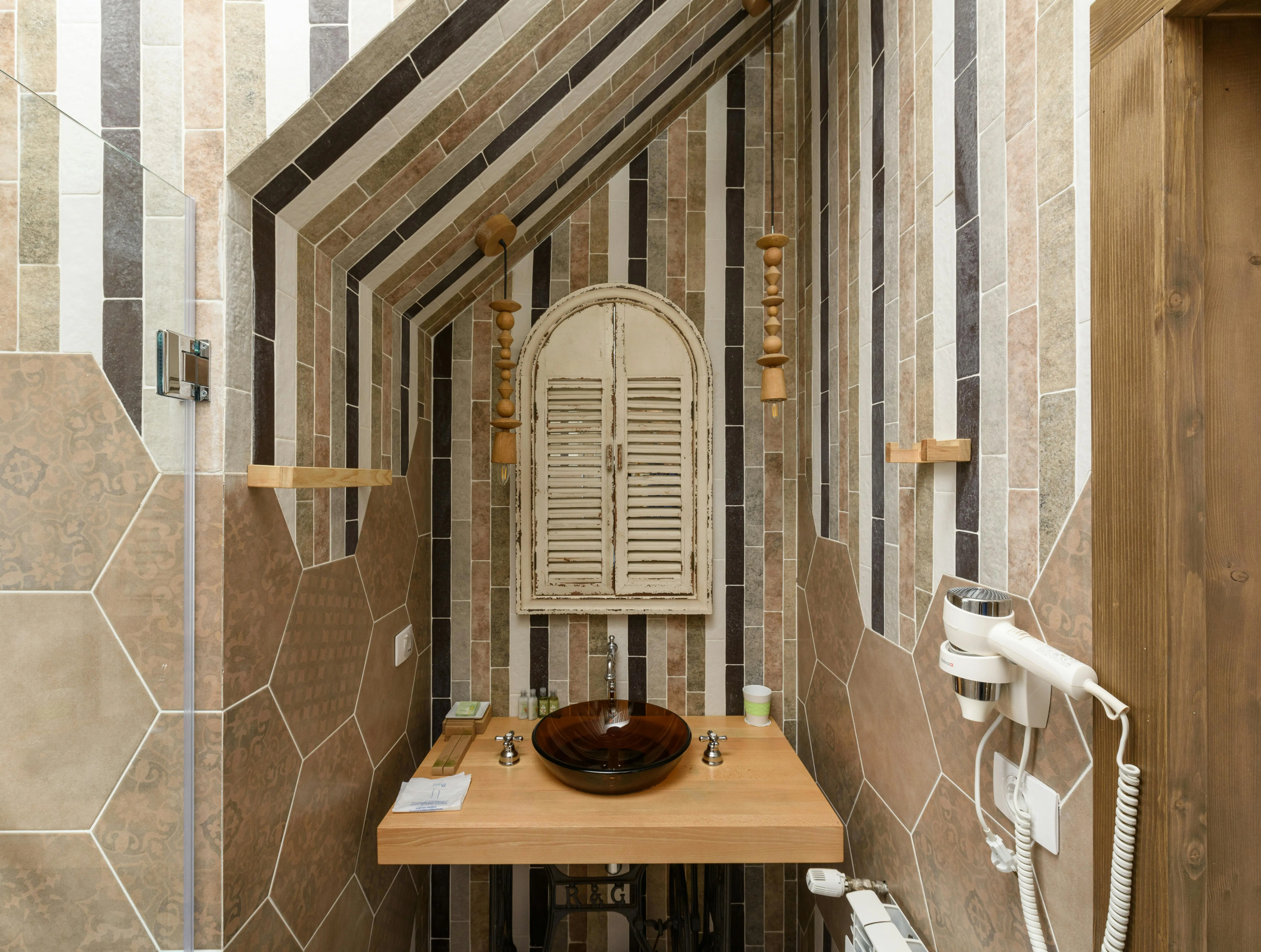 brown tiles A modern bathroom featuring rustic elements and patterned tiles for a chic design.