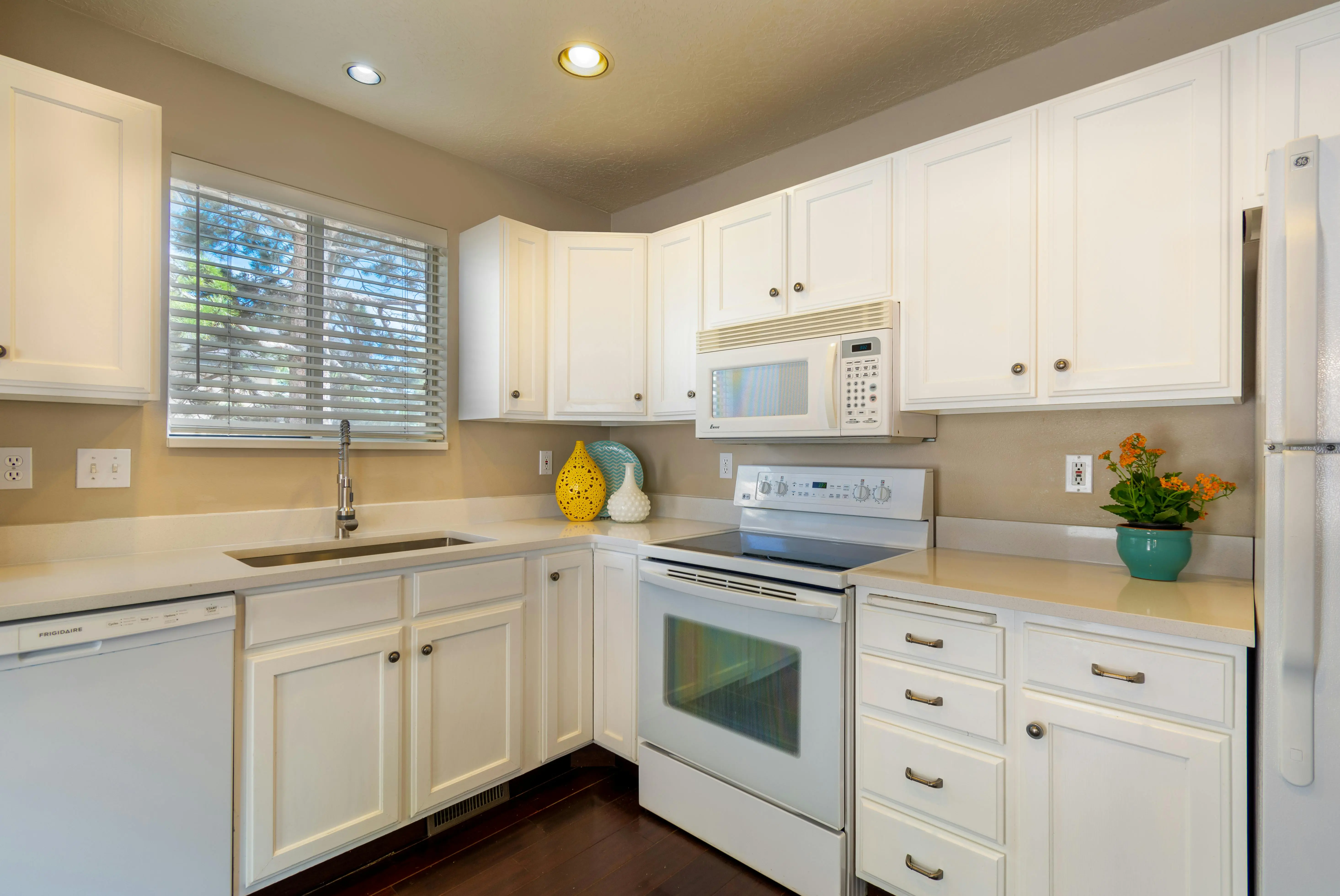 oak cabinets white Bright and clean white kitchen featuring modern appliances and sleek design.