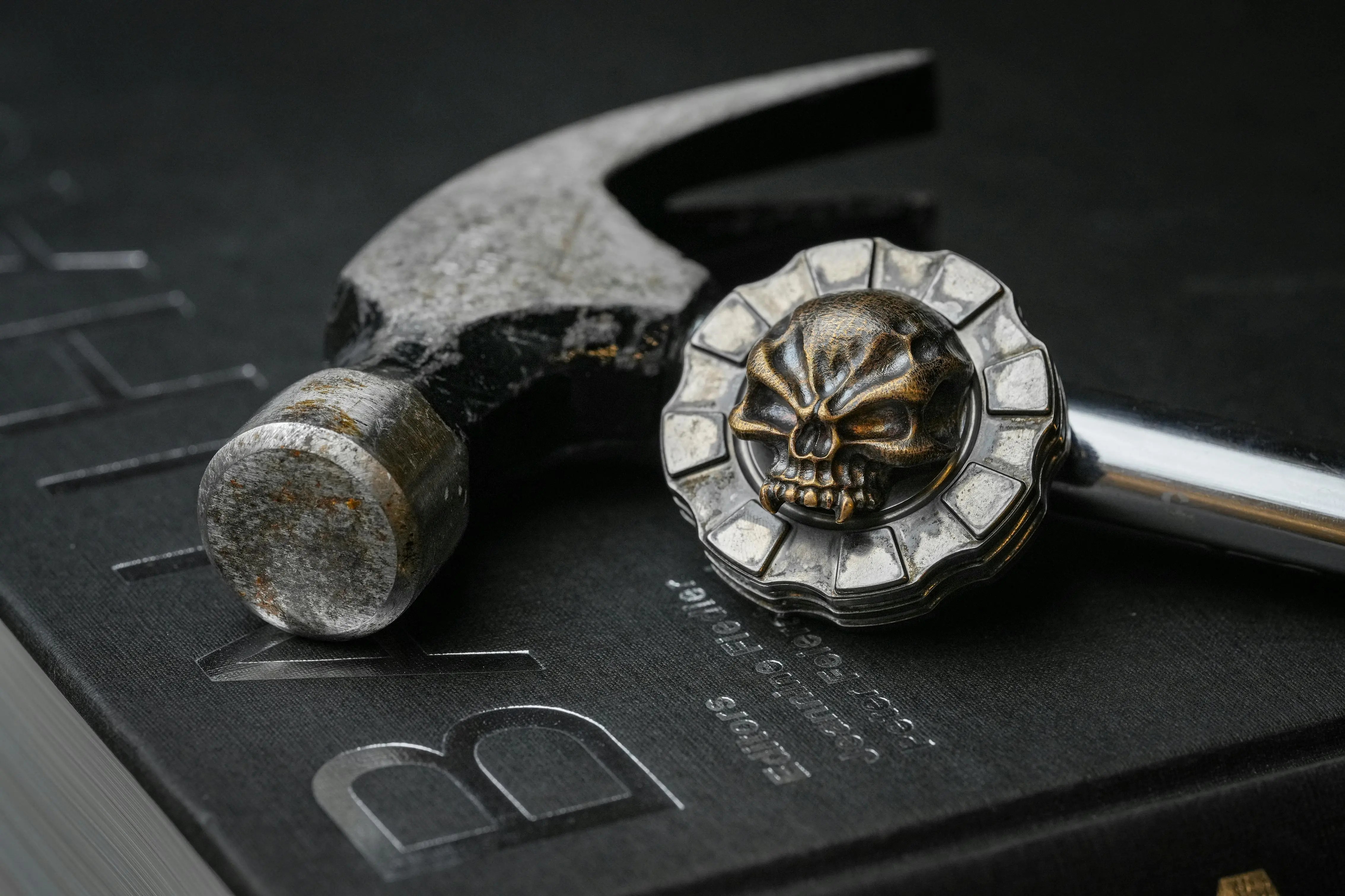 black drawer pulls Close-up of a weathered hammer and skull pendant on a black surface, creating a dark and moody atmosphere.