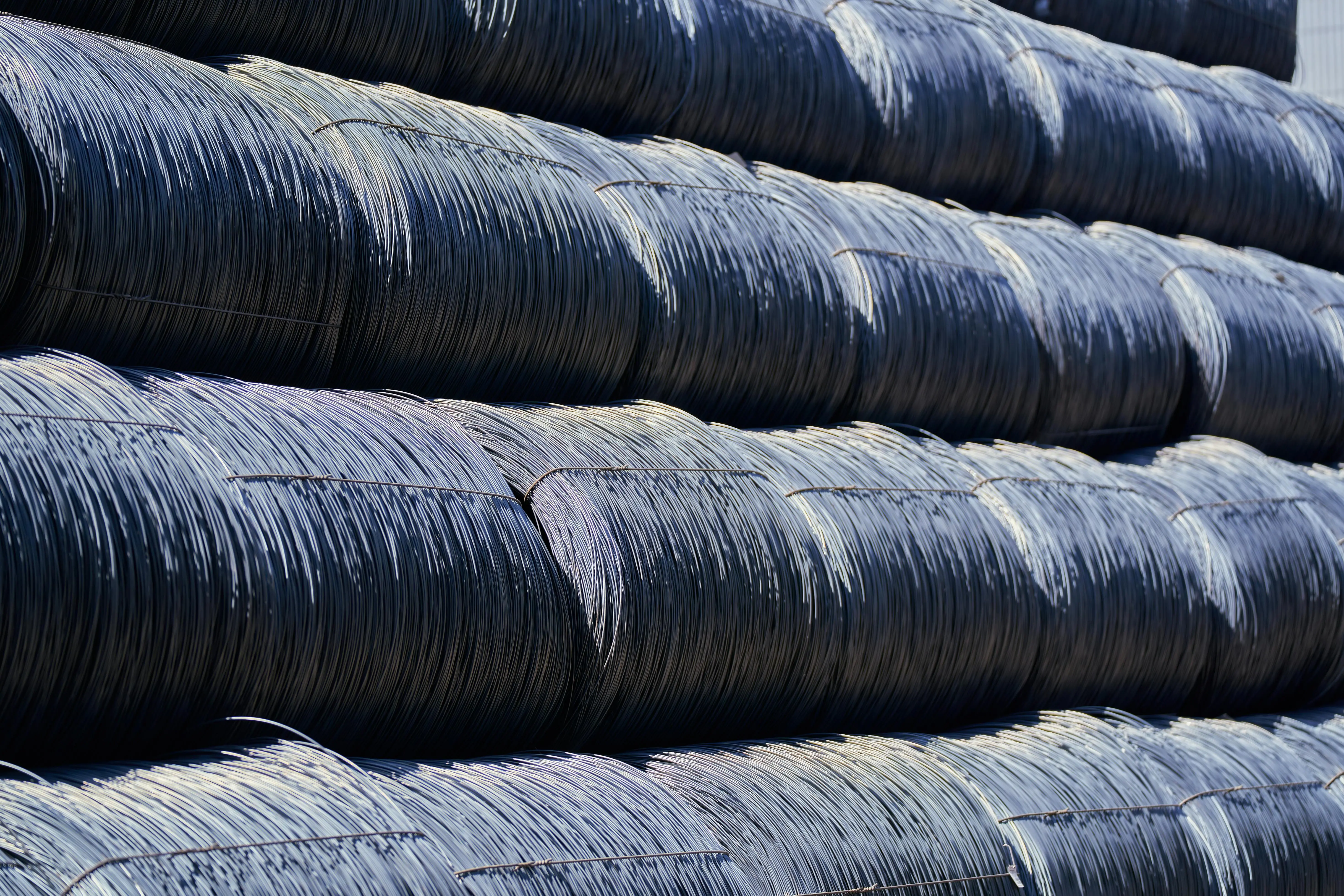 how to clean evaporator coil Close-up of stacked industrial steel wire coils glistening in sunlight.