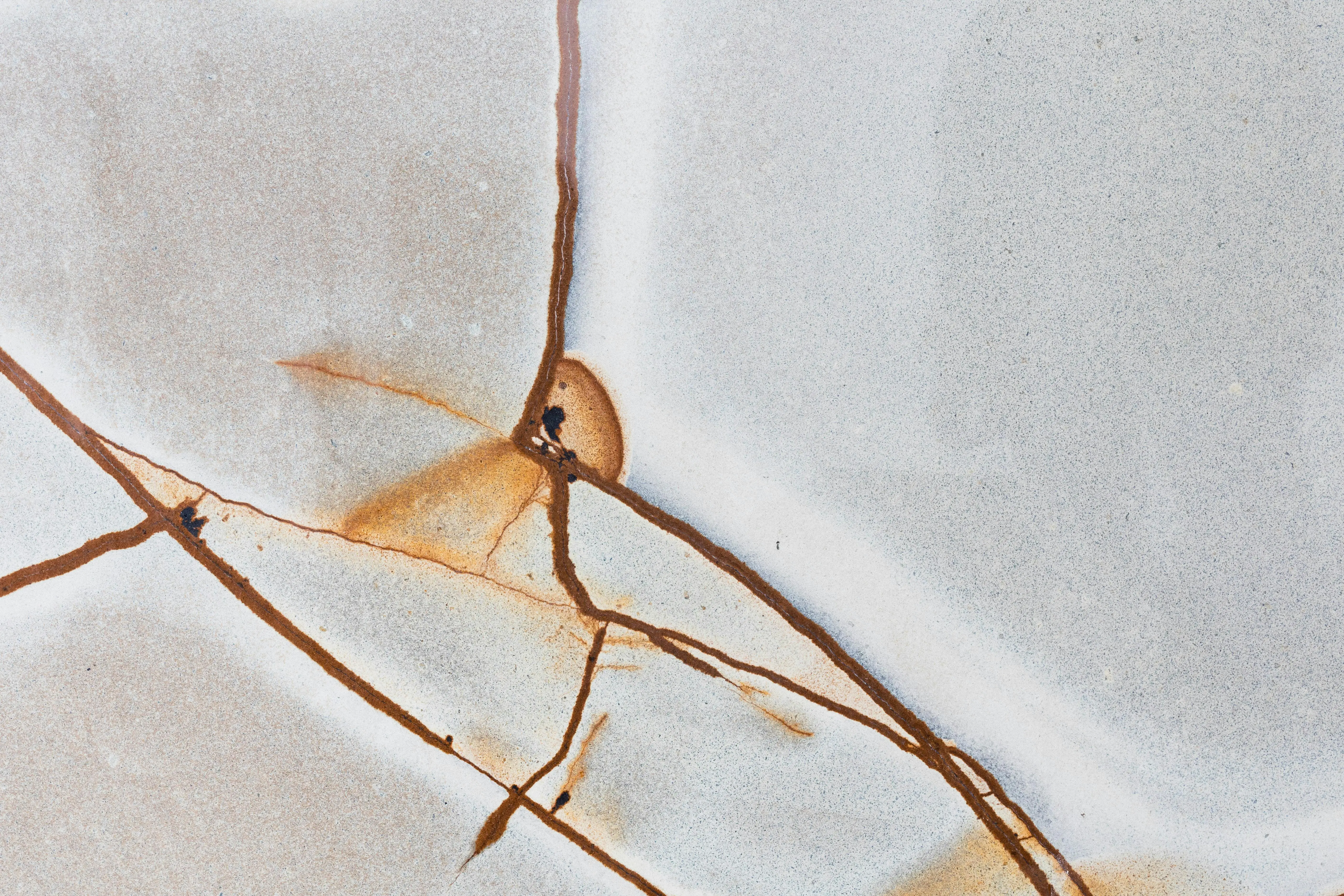 cracked sink repair Detailed macro shot of a cracked and textured surface with unique rust patterns.