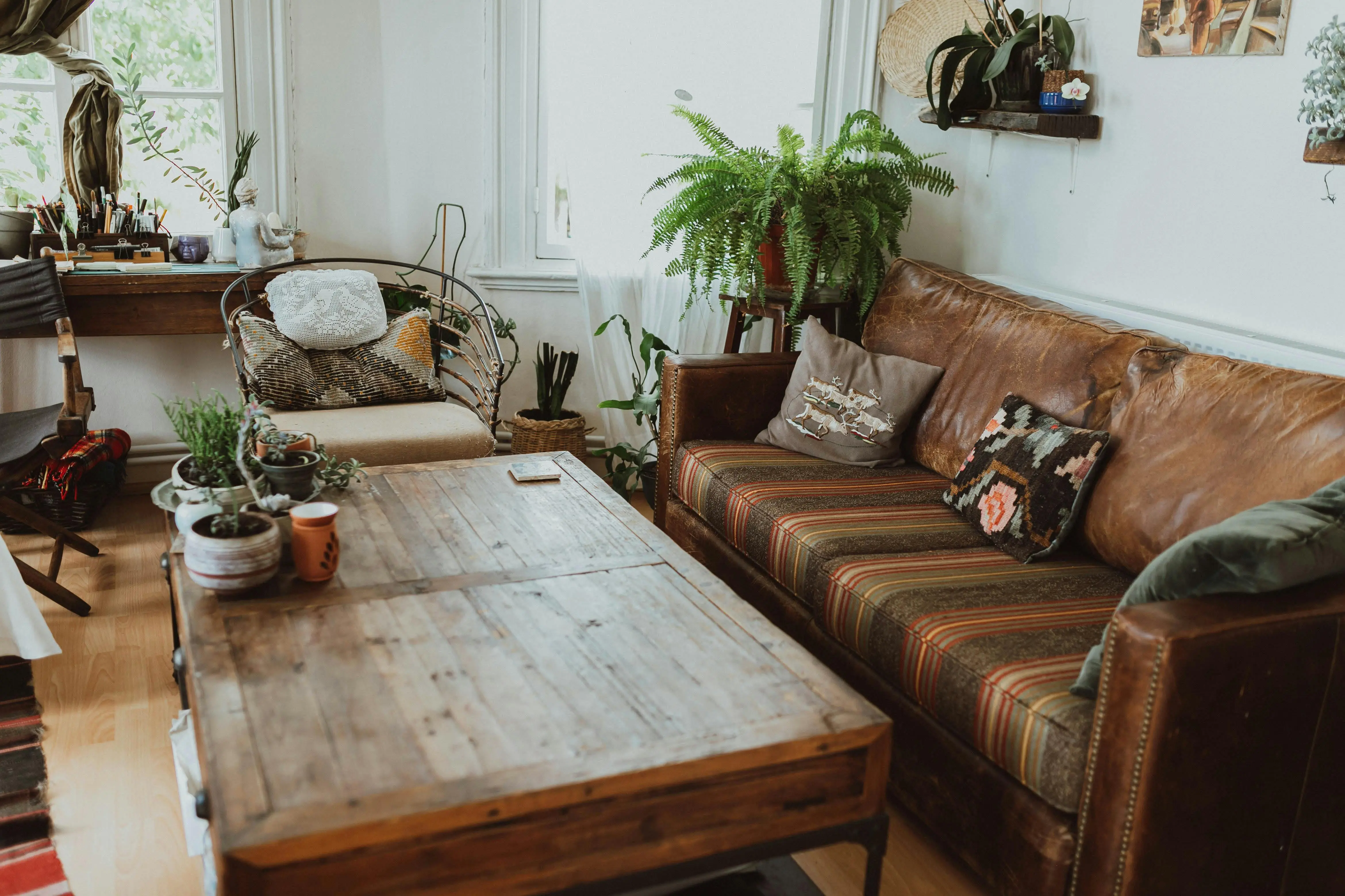 what might be placed in a secondary furniture A cozy living room featuring rustic furniture and lush greenery for a relaxed ambiance.