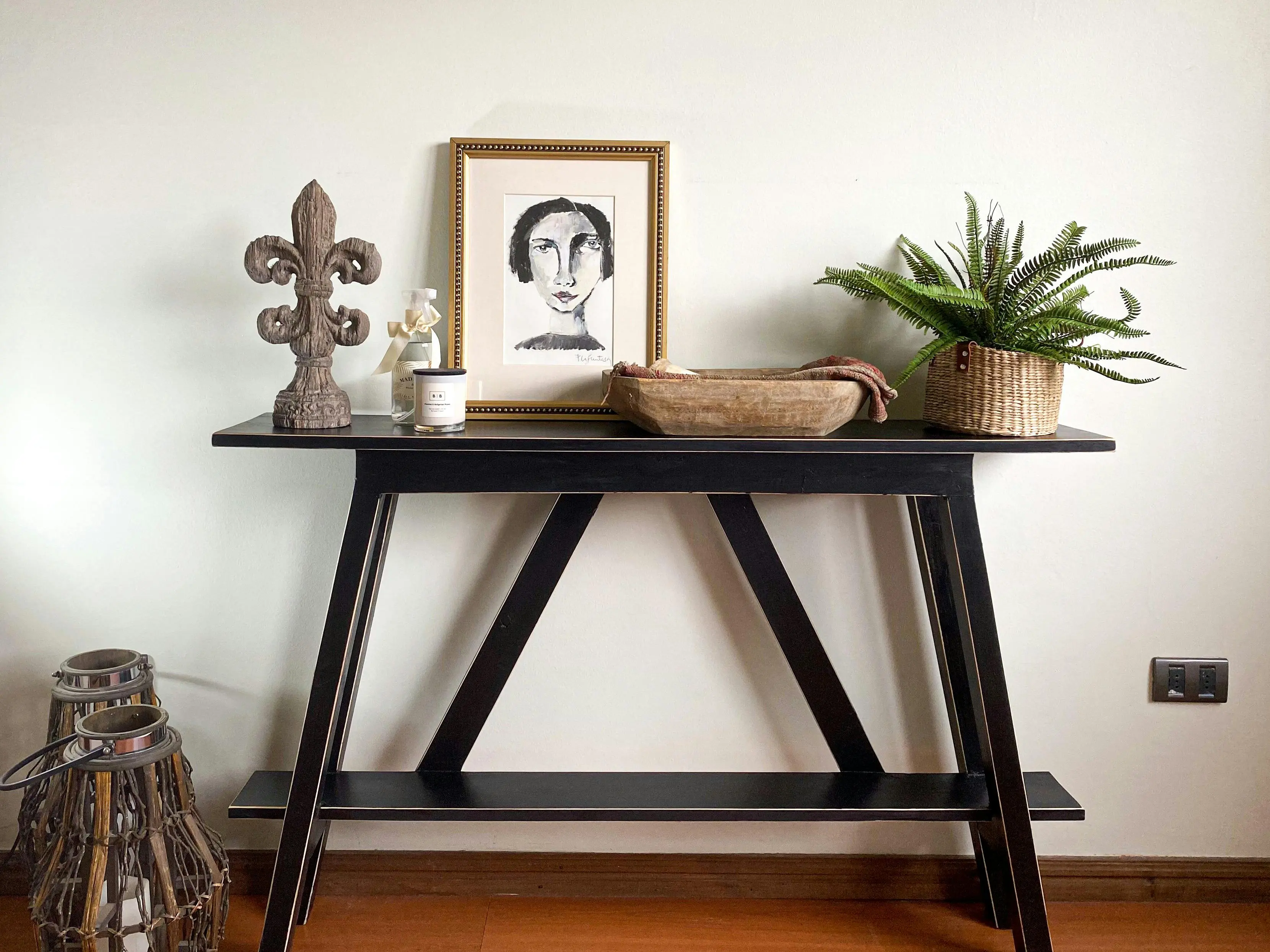 what might be placed in a secondary furniture Elegant black console table with decorative items, perfect for modern interiors.