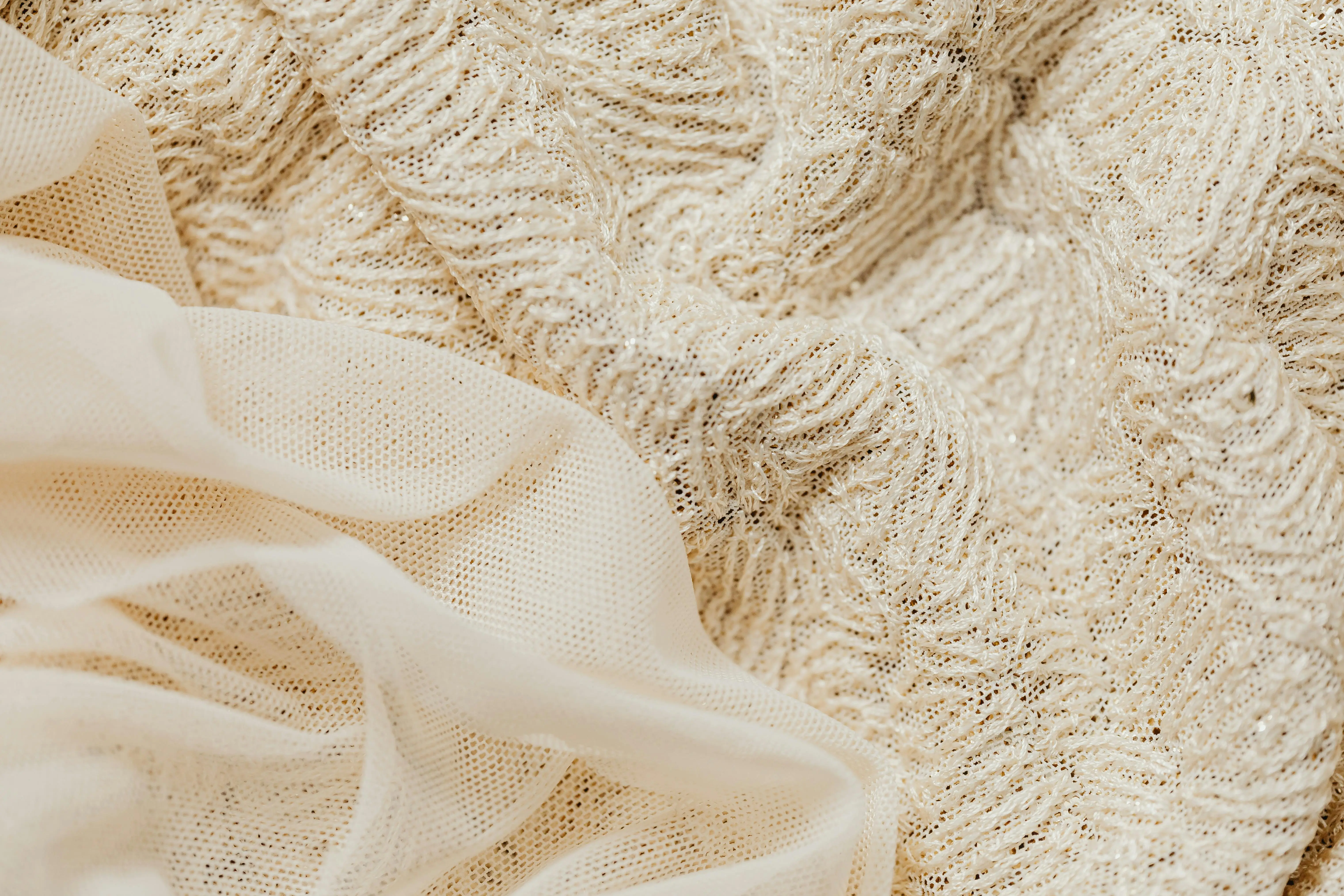 how to clean upholstered furniture Close-up view of intricate beige lace fabric and sheer material, ideal for fashion and textile projects.