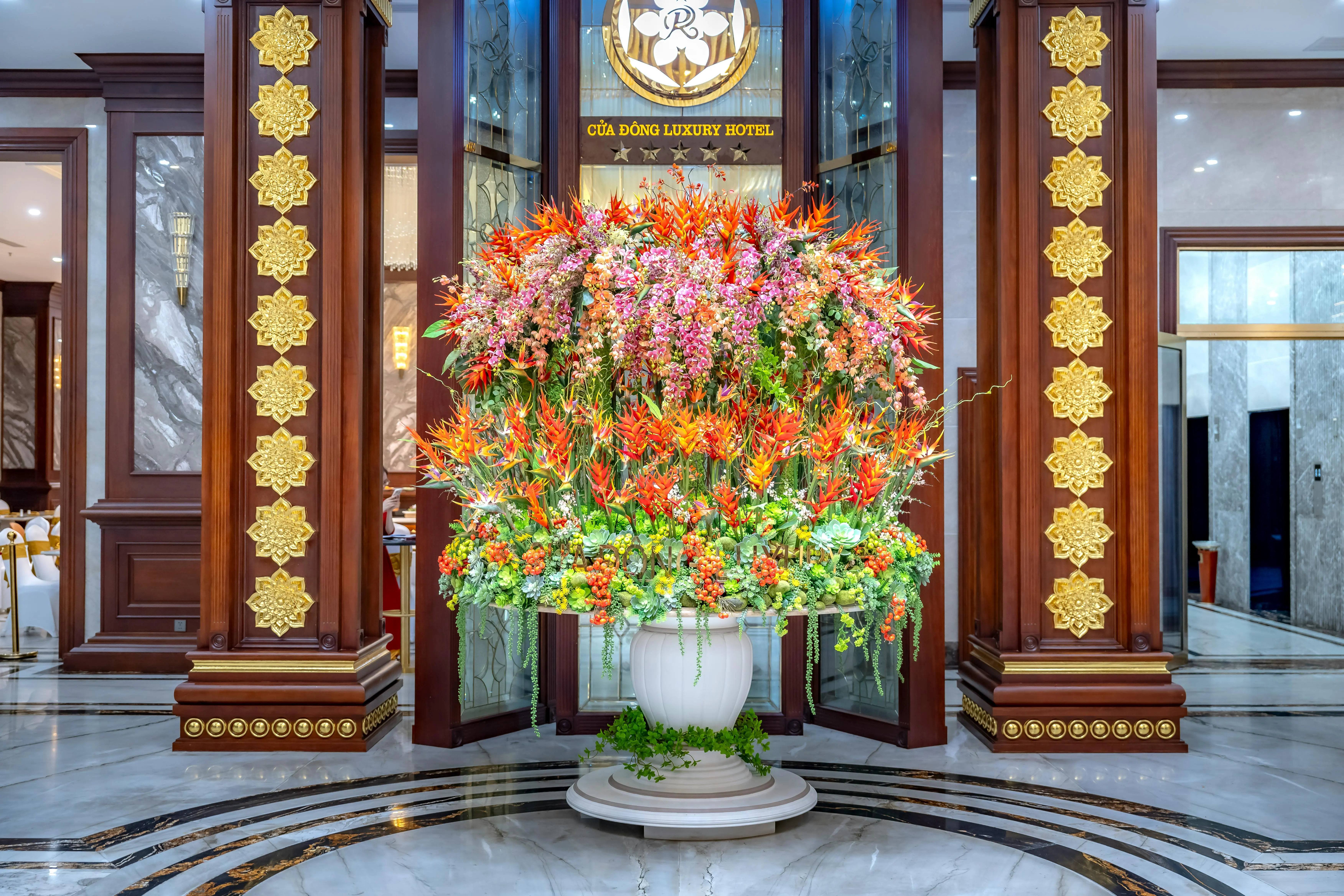 tall indoor house plants Elegant hotel lobby showcasing a vibrant floral arrangement in a classic setting.