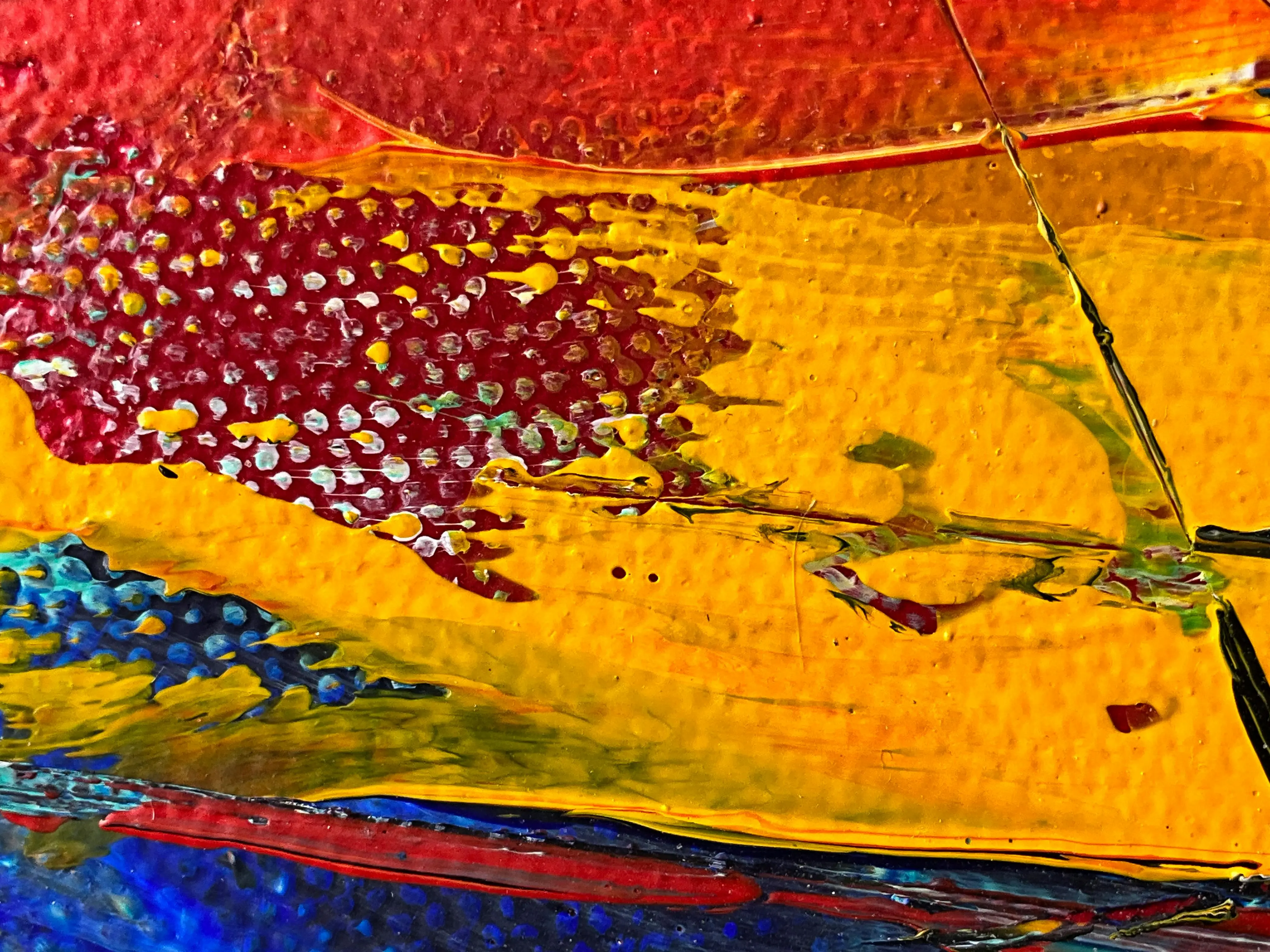 how much does a handyman charge to paint a room Close-up of vibrant, colorful abstract painting with rich textures and layers of paint.