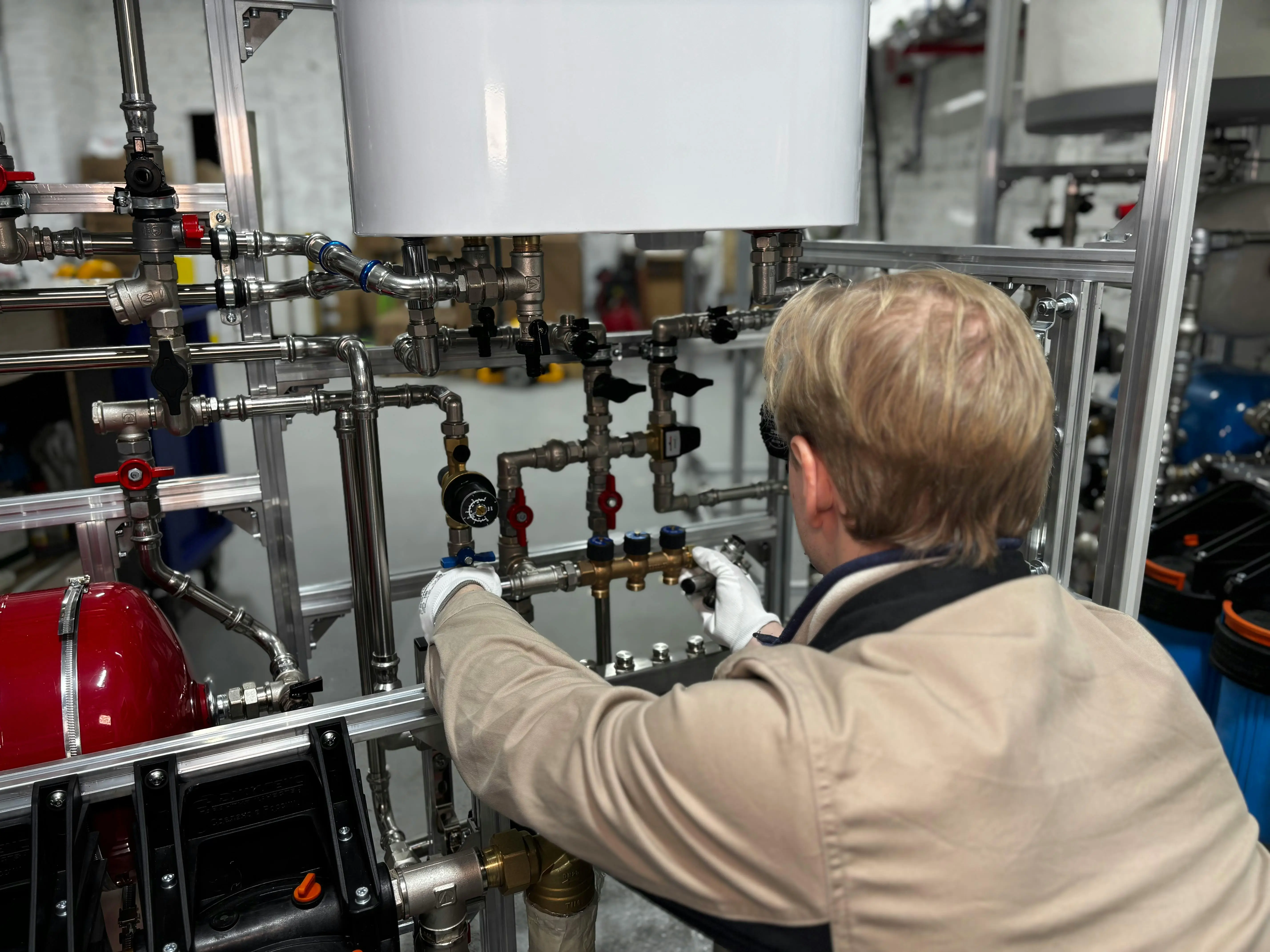 cost to replace shower valve Engineer working on industrial pipe system in a factory for heating and production adjustment.